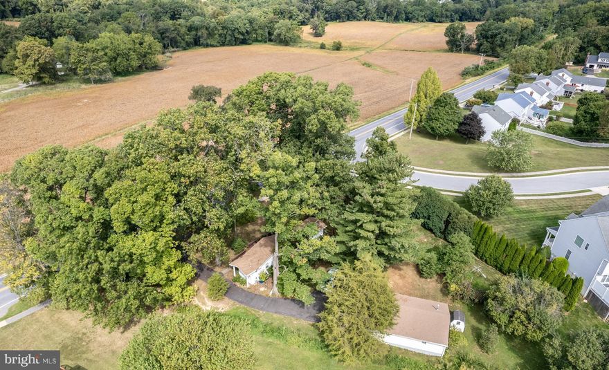 Picturesque level lot with mature oak trees the perfect setting for your new home. Property includes three bedroom mobile home, large detached four car  garage / shop. Property is served with public water with private septic, public sewer may be available buyers responsibility to verify with county. Mobile home, garage are being sold strictly as-is. Gorgeous country setting just minutes from shopping, restaurants and downtown Sykesville.