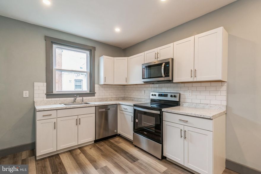 Beautiful brownstone home with grand stoop and trex deck in front. Tastefully renovated 3 bedroom home complemented by a full basement and garage in back. Stainless steel appliances and lovely renovated kitchen.  Stylishly fully redone bathroom. Great for a family to live in or buy as an investment to rent out. Cute neighborhood with lots of shopping nearby.