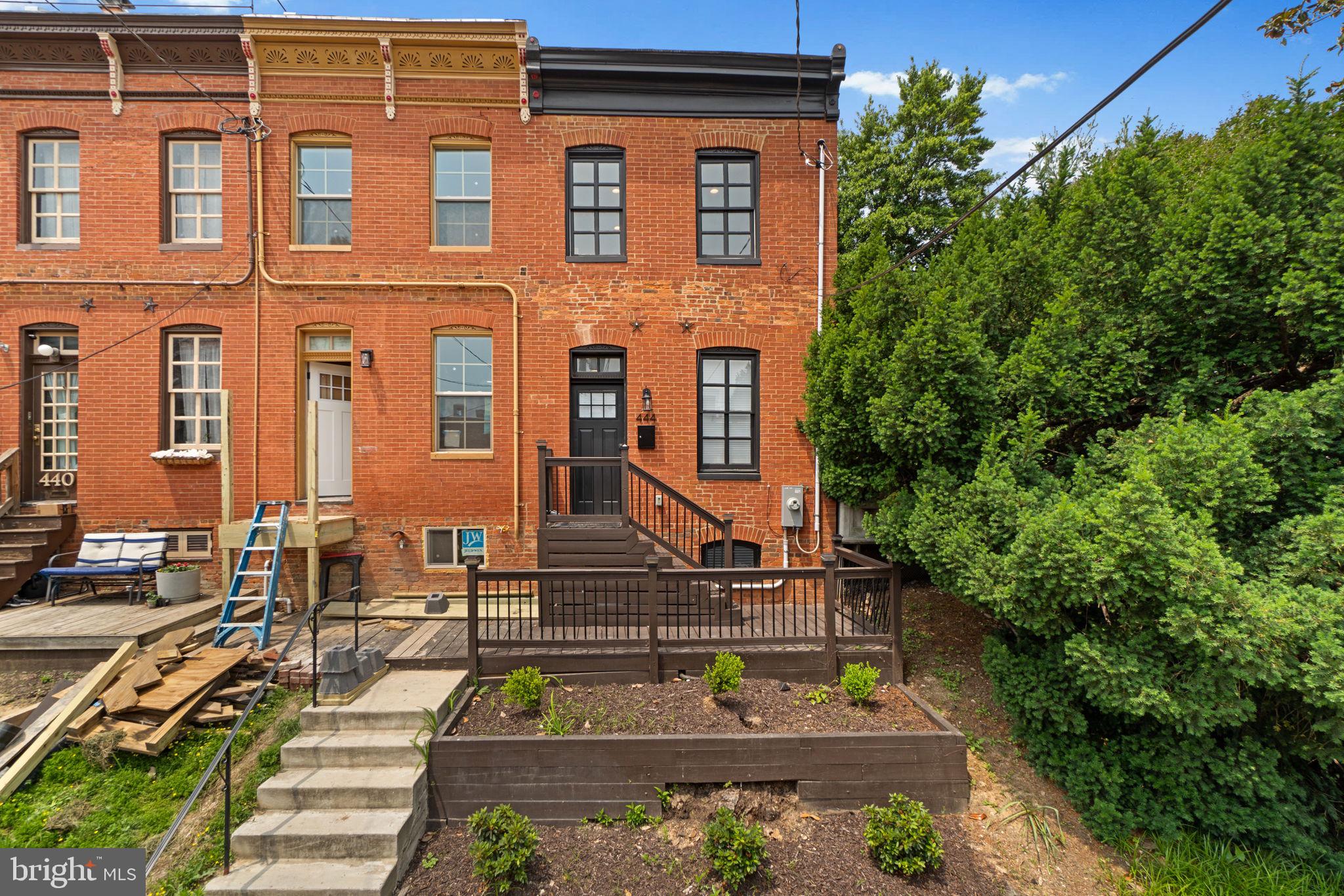 Experience the perfect blend of historic charm and modern living in this stunning end-of-group townhome in the heart of Historic Federal Hill! This beautifully renovated home offers an open-concept design with sleek dark eucalyptus floors throughout and energy-efficient, all-electric systems and appliances. The spacious living room features exposed brick walls on both levels, gleaming hardwood floors, and a convenient half bath. The modern kitchen is a chef’s dream, boasting white quartz countertops, stainless steel appliances, custom banquette seating, and a large island with ample cabinet space. Upstairs, you'll find two en suite bedrooms, each with fully updated baths. The rear bedroom opens to a private 12x8 deck, where you can enjoy peaceful water views. A skylight in the hallway bathes the space in natural light. The lower level is dedicated to laundry and utilities, keeping your living space organized and clutter-free. With easy access to work, gyms, social events, and top restaurants, this home offers both convenience and style. Don't miss out on this Federal Hill gem! Better Hurry!