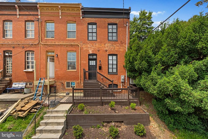 Experience the perfect blend of historic charm and modern living in this stunning end-of-group townhome in the heart of Historic Federal Hill! This beautifully renovated home offers an open-concept design with sleek dark eucalyptus floors throughout and energy-efficient, all-electric systems and appliances. The spacious living room features exposed brick walls on both levels, gleaming hardwood floors, and a convenient half bath. The modern kitchen is a chef’s dream, boasting white quartz countertops, stainless steel appliances, custom banquette seating, and a large island with ample cabinet space. Upstairs, you'll find two en suite bedrooms, each with fully updated baths. The rear bedroom opens to a private 12x8 deck, where you can enjoy peaceful water views. A skylight in the hallway bathes the space in natural light. The lower level is dedicated to laundry and utilities, keeping your living space organized and clutter-free. With easy access to work, gyms, social events, and top restaurants, this home offers both convenience and style. Don't miss out on this Federal Hill gem! Better Hurry!