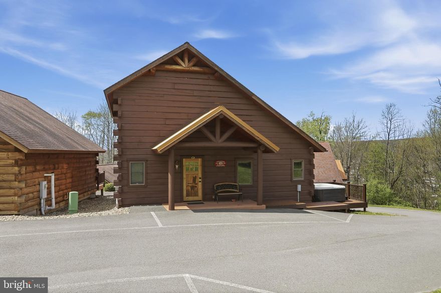Cabin #48 at The Lodges of Sunset Village offers 2 bedrooms plus a loft, 2.5 baths, approximately 1356 square feet, and comes fully furnished and turnkey. This is the largest cabin and has an unfinished basement that could be finished for additional living space or rental income!

Rich in mountain character and charm, this log cabin features uniquely carved wood doors, beautiful beamed ceilings, warm wood walls, and inviting spaces that create an authentic lake and mountain retreat feel. Additional features include lake views, ski slope views, expansive decks, upgraded finishes, open concept living, stacked stone gas fireplace, open concept living, and a hot tub. 

Enjoy incredible views of Deep Creek Lake and Wisp, along with front row seats for seasonal beauty and memorable moments, including views of the annual July 4th fireworks. This property has a proven rental history, generating approximately  $54,990  in annual gross rental income with an average daily rental rate of approximately $522, creating an exciting opportunity for buyers seeking both personal enjoyment and investment potential.

Experience one of Deep Creek Lake’s newest ownership opportunities at The Lodges at Sunset Village. For the first time ever, fully furnished lake area cabins are being offered for individual ownership in a breathtaking community featuring incredible lake and Wisp ski slope views. Community amenities include lake access with 10 shared dock slips and an impressive 1,320 square foot waterfront dock area perfect for fishing, swimming, launching kayaks, relaxing by the water, and enjoying summer fun at the lake. Residents and guests also enjoy a lakeside gazebo, playground, fire pit, gathering areas, pet-friendly accommodations, abundant parking, and on-site professional management.

The monthly condo fee provides exceptional convenience, including most utilities, snow removal, trash service, and yard maintenance, for a low-maintenance ownership experience. Whether you're searching for a vacation retreat, income-producing investment, or both, The Lodges at Sunset Village offers a rare opportunity to own at Deep Creek Lake. Stop by our on-site Sales Center at The Lodges Gatehouse during open hours to learn more, explore ownership opportunities, and get your questions answered: Thursdays 2:00–6:00 PM, Fridays 1:00–5:00 PM, Saturdays 10:00 AM–5:00 PM, and Sundays 10:00 AM–2:00 PM or call today for details and your private showing!