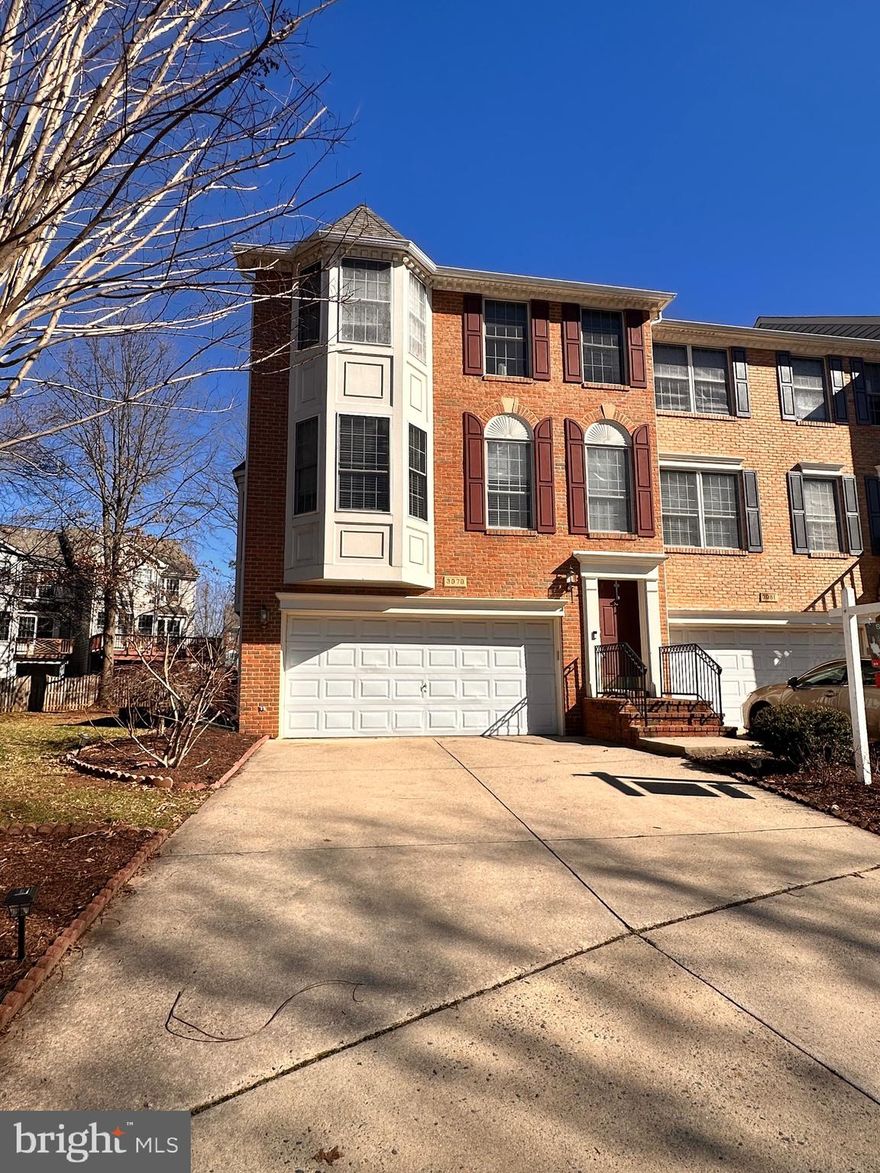 Elegant 3-level brick townhome featuring bay windows, a gourmet kitchen with quartz countertops, island, and stainless steel appliances. Spacious living room with newer hardwood floors. Primary suite offers a Jacuzzi, rain shower, and walk-in closet. Enjoy a private patio, fenced backyard, and bedroom-level laundry. Recent updates include kitchen, baths, flooring, deck, and roof. Prime location near Fair Oaks Mall, Fairfax Corner, and major routes Rt 50, Rt 29, and I-66.