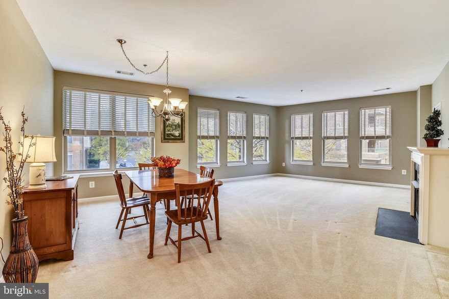 Wonderfully BRIGHT and SPACIOUS CORNER UNIT right across from Reston Town Center!   LOADS OF WINDOWS and a HUGE KITCHEN with ISLAND and table/gathering room and another big window are a few of the rare features you'll find here.  Very different floor plan makes this unit super attractive!  Den is right across from the kitchen and can be your perfect office/hobby/family room.  Generous Bedroom and Closet spaces, and updated baths and appliances.  Freshly painted so you can move in and enjoy the holidays!  This unit also has an extra storage space with shelving for your convenience.  WALK TO SHOPPING, ENTERTAINMENT, FABULOUS RESTAURANTS, MOVIES, AND SOON, A BRAND NEW METRO STATION!  This is an opportunity you don't want to miss!
