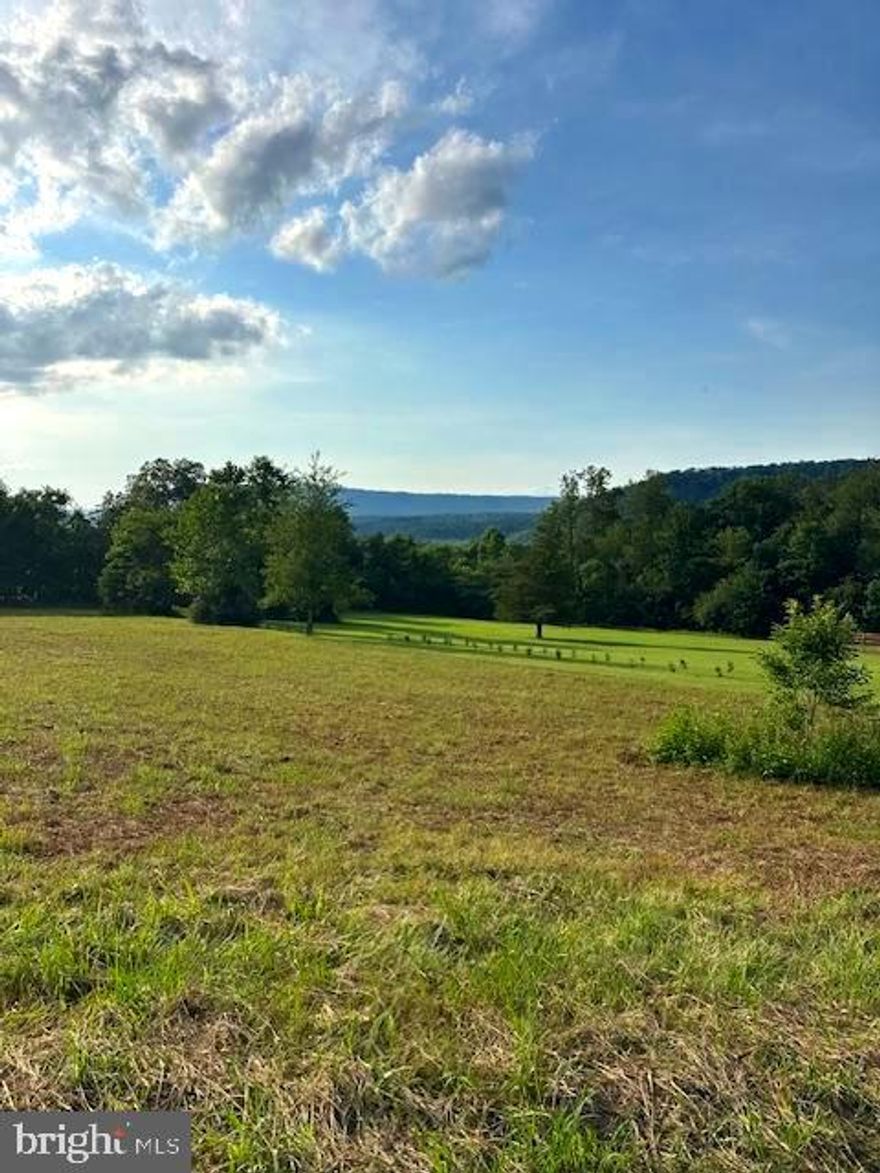 Beautiful 2.13-acre lot with stunning mountain views and plenty of level ground—perfect for building your dream home, starting a garden, or enjoying outdoor activities. The property has been perked and surveyed, making it ready for your plans.  Located just minutes from the Cacapon River, offering easy access to fishing, tubing, kayaking, and swimming. Only 7 miles from historic Berkeley Springs, known for its natural hot springs, charming downtown, and year-round recreation. Peaceful setting with the best of both nature and convenience!