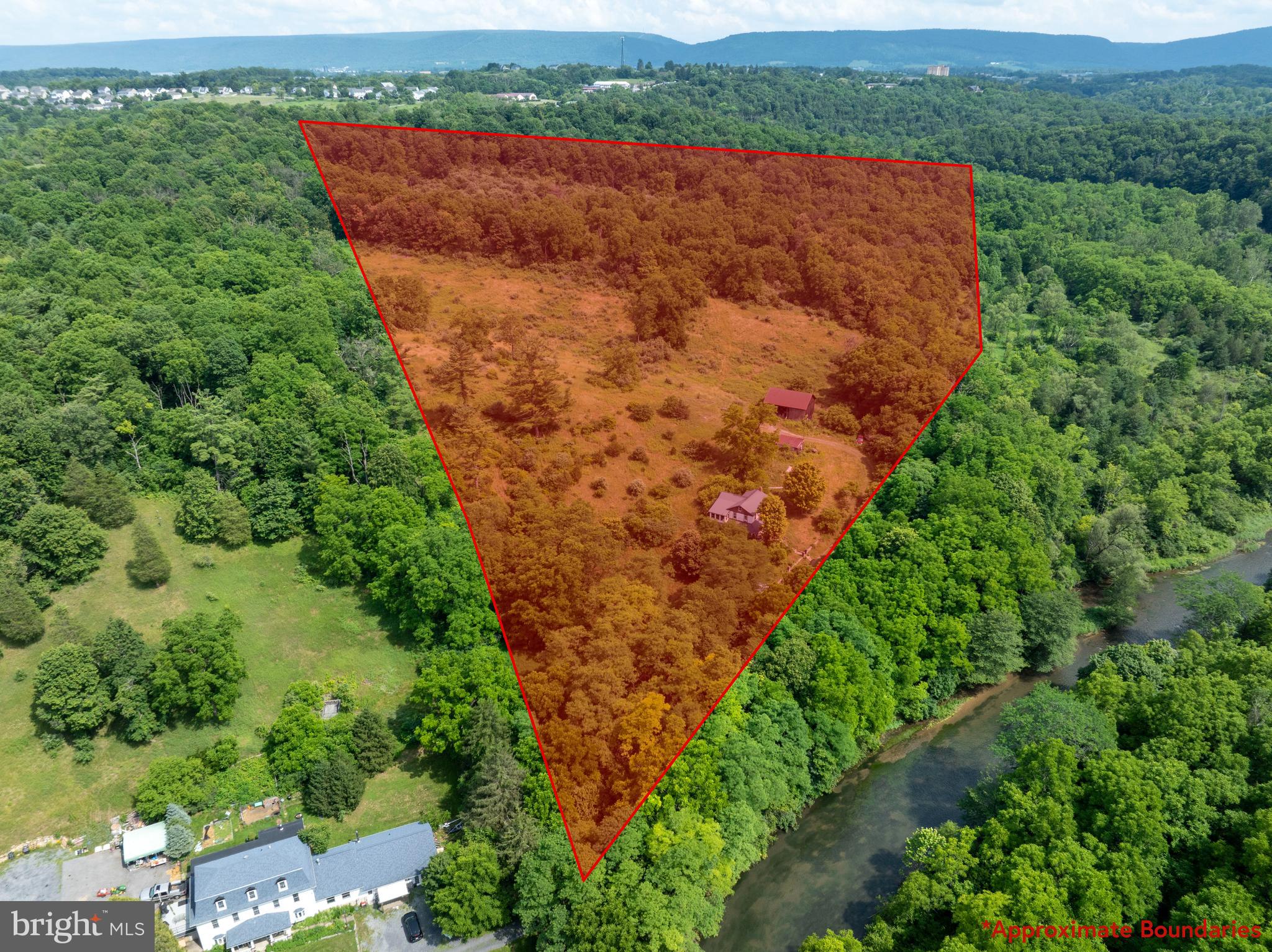 Own 27 acres of rolling countryside in Bellefonte, where open meadows, wooded hillsides, and frontage along Spring Creek create a truly one-of-a-kind setting. The property directly borders State Game Lands, offering endless opportunities for outdoor recreation and exploration right out your back door. With a blend of grassy fields and mature trees, this land is ideal for building your dream home, creating a private retreat, or simply enjoying the peace and privacy of the natural surroundings. A vacant home and small barn is currently on the property and will be included in as-is condition.
