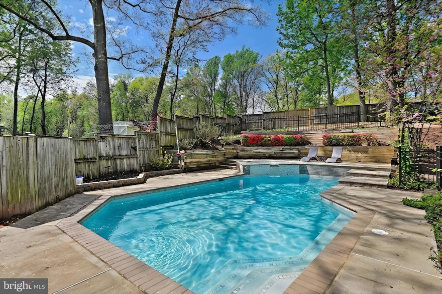 Your private retreat awaits — and it comes with a heated pool. Tucked at the end of a cul-de-sac and backing to open green space, this stunningly updated 5-bedroom, 4-full-bath colonial in Fox Mill Estates is the one you've been waiting for. Mature cherry blossom trees planted in the front yard (2023) greet you with a stunning seasonal welcome. Out back, a fully fenced yard delivers resort-style living: a 32x18 heated in-ground pool (3–7 ft depth), an 8x6.5 hot tub/spa with 8 jets, a sun-soaked deck for entertaining, and a level lawn area beyond the fence — all framed by the privacy of common land with no rear neighbors. Step inside to a completely reimagined kitchen with quartz countertops, soft-close cabinetry, and a gas cooking conversion with an exterior-vented hood — the kind of kitchen that actually makes you want to cook. The open flow from kitchen to family room (with fireplace) to back deck is exactly how a home like this should live. A main-level bedroom with private en-suite bath and exterior access is ideal for guests, in-laws, or a home office that doesn't feel like a closet. Upstairs, the primary suite offers vaulted ceilings and a spa-worthy bathroom with a 9-panel 360-degree shower system. Two additional bedrooms, a remodeled hall bath, and an upper-level laundry room round out the floor. The fully finished lower level adds a legal 5th bedroom, 4th full bath, spacious recreation room, LVP flooring (2022), and a bonus room perfect for a home office, gym, or playroom. The updates list is long and meaningful: new hot water heater (2025), new dishwasher (2025), pool heater (2024), complete kitchen renovation, remodeled bathrooms, new HVAC, windows, hardwood floors on main and upper levels, and much more — this home has been lovingly maintained and consistently upgraded. All of this on a private third-acre lot in Fox Mill Estates. Zoned for top-rated Fairfax County Public Schools — and families with high schoolers will want to note that 9th and 10th graders may opt in to attend the new Skyview High School starting in 2026–2027. Minutes to the Silver Line Metro, Dulles Corridor tech employers, Route 7, and the Fairfax County Parkway. This is the move-in-ready pool home in Northern Virginia you've been searching for.