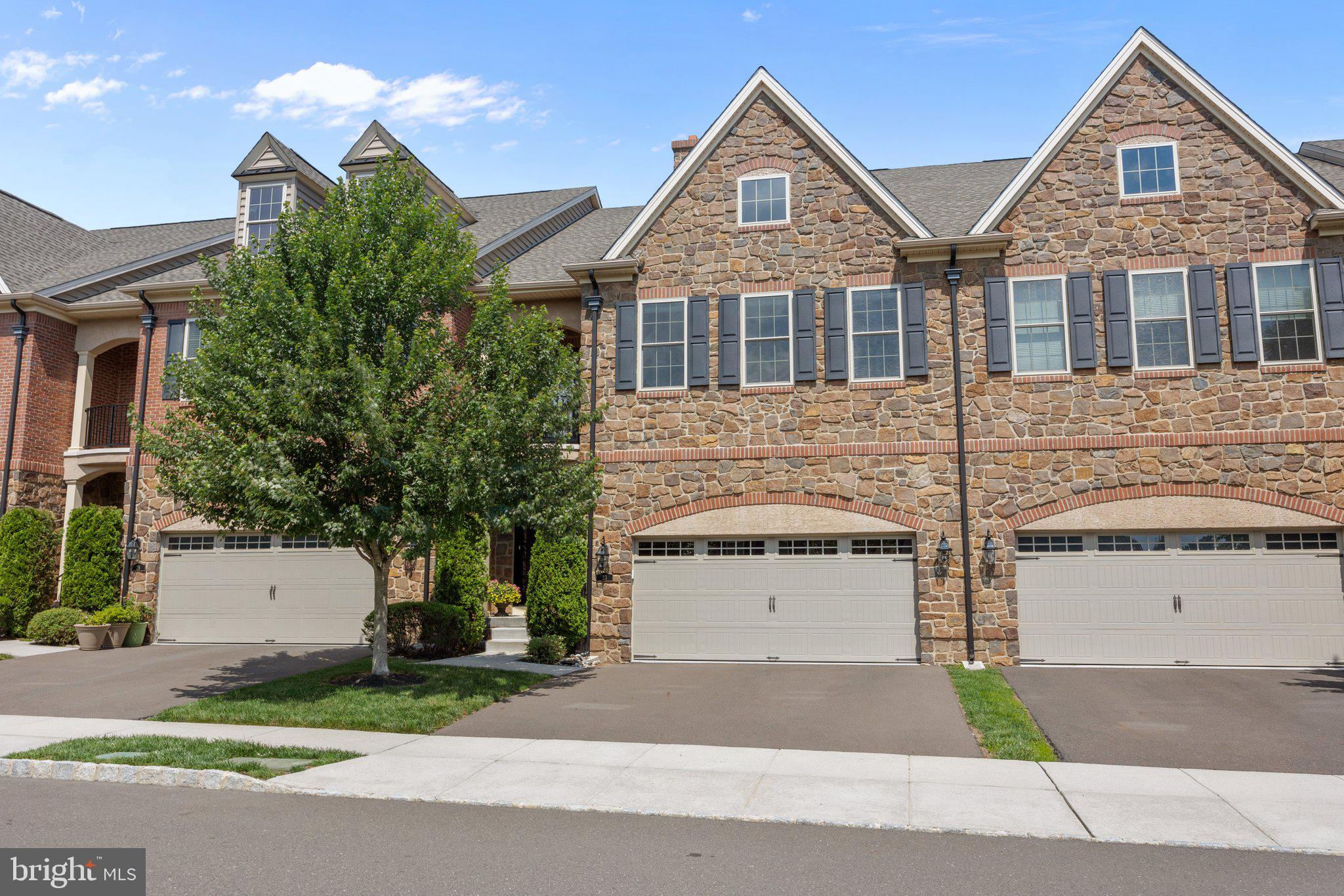 Welcome to luxury living at its finest in sought-after Walden Square—just a short stroll to charming downtown Newtown Boro! This immaculate townhome blends timeless elegance with modern convenience, offering three levels of beautifully designed space. Step into the grand foyer featuring custom wainscoting and pristine hardwood floors that flow throughout the home, enhanced by a designer color palette, crown moldings, and soaring 9-foot ceilings. At the heart of the home lies a stunning gourmet kitchen equipped with a premium appliance package, counter-to-ceiling glass tile backsplash, granite countertops, custom pantry cabinetry, and a massive center island—perfect for casual meals or lively conversation. Seamlessly connected is a spacious family room with a cozy gas fireplace and a dramatic dining room with wainscoting and boxed-beam ceiling detail—ideal for both entertaining and everyday living. Upstairs, discover three generously sized bedrooms, each with hardwood flooring, recessed lighting, crown molding, and abundant closet space. The luxurious owner's suite offers a versatile flex area—ideal as a private sitting room or office—along with a charming Juliette balcony and elongated windows for added elegance. Two custom walk-in closets provide boutique-style wardrobe organization, while the spa-like ensuite bath boasts upgraded tile, granite counters, linen closet, and a private water closet. The fully-finished lower level presents a rare bonus: a FOURTH bedroom and FOURTH full bath—perfect for guests, an au pair, or returning college student. Additional finished space can accommodate a media room, home gym, or hobby studio, with ample room for storage. Set on the outer perimeter of the community for added privacy, this home also features a maintenance-free deck for outdoor aperitifs and summer grilling! Additional perks of this home are three-zone gas heating and unbeatable access to I-95, I-295, top-rated schools, shopping, dining, and medical facilities. Every inch of this home is designed with care and quality—ready to welcome its next discerning owner.