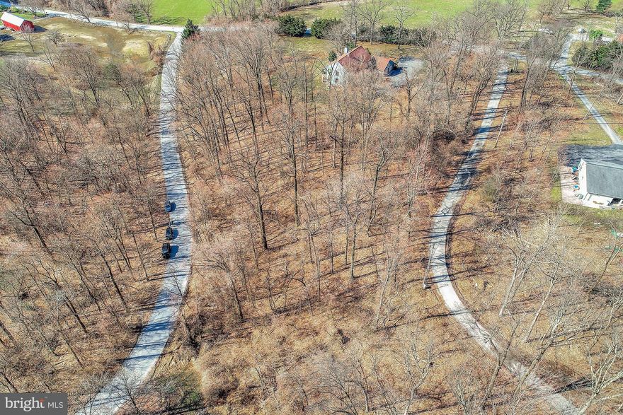 Ideal wooded lot w/southern exposure. Located in Deerhill Estates, an established rural neighborhood of custom homes. Large lots with elbow room. Bring your builder or we have builders interested in helping you layout your dreams! Seller has a zoning variance that restores the rear setback line to 40ft; side setbacks are 30ft. The southeast corner of the buildable area (the land within the setbacks) is marked making it easy to visualize placement. A house placed here would have the shortest driveway and shortest distance to the utility pedestals. The terrain is deal for walkout basement and/or basement garage.