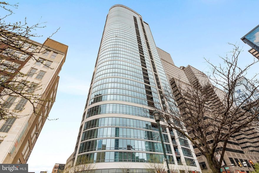 This sun-filled corner home offers two bedrooms plus a den off the living room, with glamorous sun filled southern views to the Schuylkill River and an eastern view stretching all the way to City Hall.The location of this home feels like you are literally perched over the street giving you that true Center City excitement. A gracious foyer welcomes you into rich flooring throughout, leading to an open kitchen with a window as well as a breakfast bar, granite counters, and stainless steel appliances. The spacious living and dining area is lined with dramatic floor-to-ceiling windows and the inviting balcony is conveniently situated off of the kitchen/dining area. The den, also wrapped in glass, includes a convenient full bathroom with a stall shower, while the well-sized second bedroom sits just across from the second full bathroom. The primary bedroom suite features generous closet space and a luxurious bathroom with both a soaking tub and a separate stall shower. The Murano is a full-service 24/7 doorman building, and this residence includes a coveted indoor garage parking space with direct lobby access.There is a full sized storage space on the 4th floor which is included in the sale as well.  Residents enjoy an expansive community terrace, a fitness center, and a stunning indoor pool—all just steps from Trader Joe’s, excellent dining, and a short stroll to the elegance of Rittenhouse Square.  (condo fee includes $45.00 per month for condo parking fee- parking space # 335 and storage #4056)