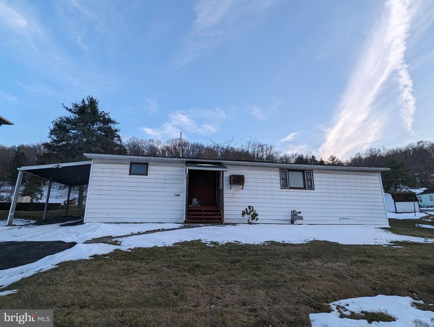 This place has a great location and a great yard. The house itself is a manufactured home that has been neglected and is serious need of some love. A great gas freestanding fireplace that can heat the whole place. Open concept living with some elbow grease...what you see is what you get To settle an estate.  Sold strictly as is. Priced to be a cheap roof over someone's head with some effort and imagination.
Driveway and carport too! This is priced right. Don't wait!