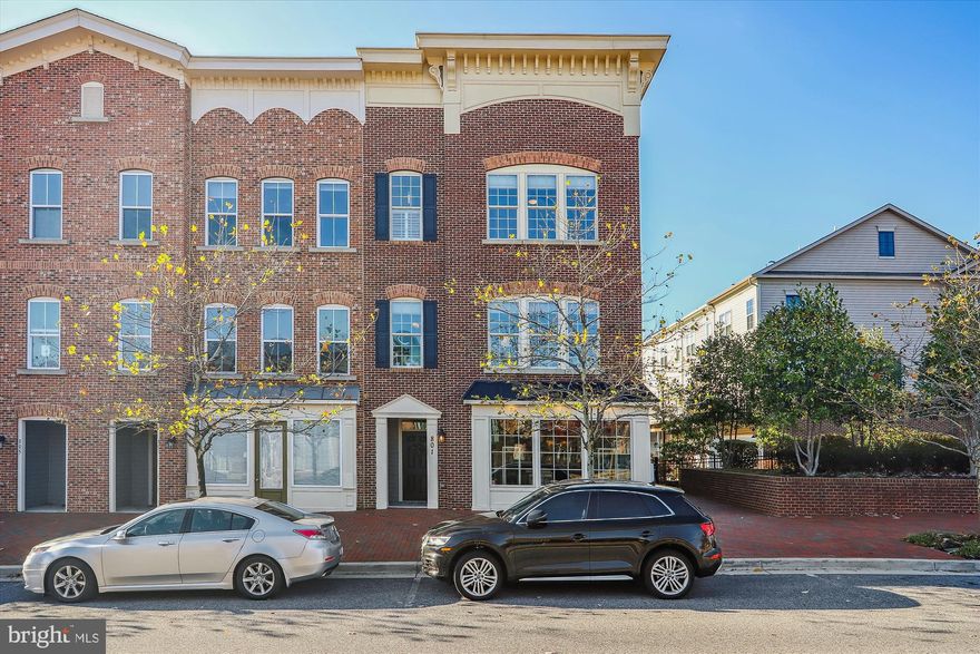 VERY RARE OPPORTUNITY to own one of only 12 specially zoned "Live/Work" luxury townhomes in Village Greens Of Annapolis. These homes offer commercial space store fronts with separate entrances and the opportunity to have a business on the lower level. Initially, you may want to use the space as a family room, a workshop, or an Au pair suite. However, with the special zoning you will always have the opportunity to use it for a commercial venture... Perhaps, a law office or that boutique you've always wanted to open. This particular home is also an END UNIT. With 14 more windows than a typical interior unit you'll have natural light flooding every room! The lower level half bath has also been converted to a full bath with shower. Step into the Gourmet Kitchen and note the stylish contrast between the crisp white cabinetry and gorgeous Wide Plank Hickory Floors. These floors are hand-scraped and cover the entire main level. Quartz contertops, Stainless Steel appliances, under cabinet lighting, and a fully tiled backsplash add the finishing touches to this fabulous kitchen. Crank up the music throughout the home with a 4-zone Bose Surround Sound System. Exterior Bose speakers will drench your deck with hot tunes, but the composite surface will remain cool under the remote controlled 10'x20' Sunsetter Awning. Hunter Douglas Shades cover all windows and an Epoxy Finish covers the garage floor... with a Lifetime Guarantee! The Primary Bedroom offers a comfortable sanctuary with a well designed walk-in closet and ensuite bathroom with jetted tub and separate shower. A wall mounted Dimplex Opti-Myst fireplace will mesmerize you for hours! Special features can be found throughout the home and are too numerous to list here. BE SURE TO REQUEST the "Full List of Features". Additional photos, room dimensions, and wall measurements can be found in the VIRTUAL TOUR. Pool and other amenities available with Berkshire Annapolis Bay membership. Just minutes from Historic Downtown Annapolis and major commuter routes to Baltimore and Washington DC. You may want to see this one sooner than later! The market is hot and this very unique opportunity will not last long.