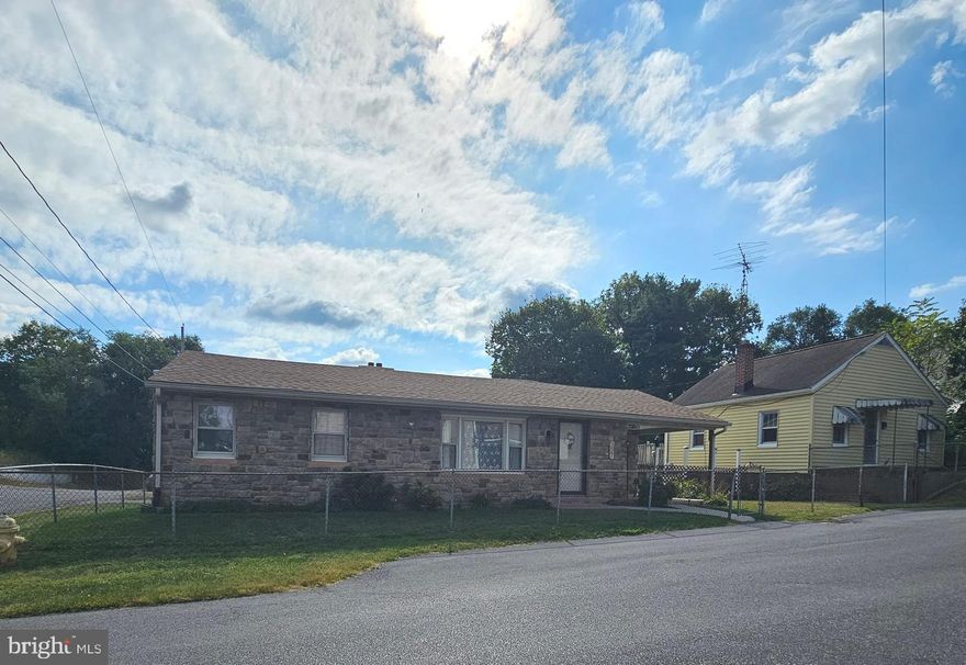 Charming rancher in the City of Martinsburg. Main house plus accessory home.  With 1,484 sq. ft. , the interior features a traditional floor plan with three bedrooms (or two and a den/office) and one full bath and half bath situated in the basement. Free-standing gas fireplace in the family room, separate dining room,  kitchen with breakfast bar and breakfast nook. The main home includes custom woodwork including many built-ins, shelving, trim and pass through spaces. The unfinished basement provides ample storage and walk up access plus inside stairs with chair lift. Set on a spacious 0.6-acre corner lot, fully fenced, architectural shingle. Located in a quiet neighborhood, residents can easily access local amenities, parks, and shopping. This property presents a unique opportunity for those looking to invest in a home with great potential for renovation and personalization.