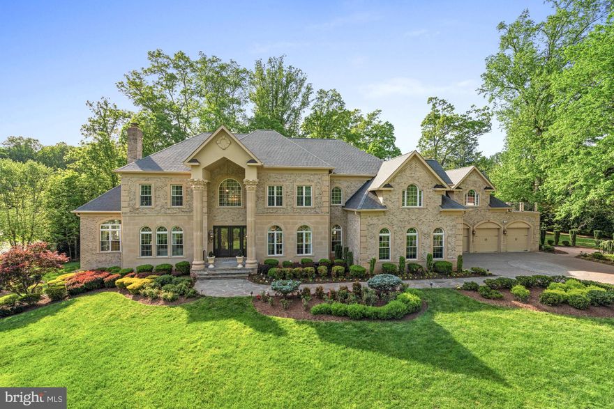 Timeless elegance, masterful design, and a Great Falls Best address on just over one acre create a dazzling first impression. As you walk through the front doors, you are greeted by a double-height foyer featuring a curved, bifurcated staircase, elegant iron railings, and marble flooring. The thoughtfully executed floor plan ensures an effortless flow from room to room. The formal living room is highlighted by a gas fireplace and receives beautiful morning sunlight. The dining room also features a fireplace and is serviced by a butler’s pantry. An inviting sunroom, flooded with natural light, is designed with sunflower-inspired decor and includes a walk-out to a sprawling two-level deck. A cozy study, tucked away just off the foyer, is designed for versatility, serving as a functional office or a serene environment for quiet reading and intimate gatherings.
The spacious great room features three distinct areas: an entertaining area with a large television, a vibrant sitting room that opens to the home's second expansive deck, and a gourmet kitchen, ideal for the home chef. This kitchen is complete with two large islands, rich designer cabinetry, and top-of-the-line appliances, including a six-burner Wolf range, along with casual countertop dining for relaxed meals. The sophisticated second level boasts five ensuite bedrooms, highlighted by a sweeping primary suite featuring a sitting room and a covered private balcony. The primary bathroom rivals a five-star spa, with a soaking tub and an oversized shower. This impressive layout continues on the lower level, showcasing an open entertaining area complete with a wet bar that doubles as a kitchenette. Enjoy a billiards area, home theater, golf simulator room, gym, and another full bedroom and bathroom. The rear grounds, perfect for outdoor living, feature extensive hardscape, a covered seating area, a pond, outdoor cooking, and a lush lawn, all enveloped by mature landscaping for ultimate privacy. This home and bodies the pinnacle of luxury living, seamlessly  combining an impressive array of modern amenities with an ideal location for an unparalleled family lifestyle.