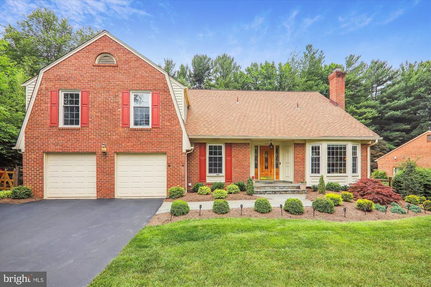 OPEN SATURDAY 12-3PM. Stylishly renovated and expanded solid brick colonial with rare five bedrooms and three full baths on the upper level and two–car garage.  Premium private 0.3-acre lot on a non-through street BACKING TO A PRIVATE WOODED COMMON AREA in the Copenhaver subdivision located in the Wootton school district.  This Kettler Brothers-built Queen Anne model boasts over 4,600 square feet of living area on three levels and has been meticulously maintained and thoughtfully improved by the owners to give you a quality-constructed home with today's design and appeal.  Special features include large formal and entertaining rooms, hardwood flooring on the main and upper levels, recessed lighting, two fireplaces, elaborate moldings, volume ceilings, skylights, and multiple built-ins throughout the entire home.  The expanded and renovated kitchen is highlighted by an enormous center island/dining table and opens to a stunning family room with a brick fireplace flanked by built-in bookcases and glass sliders to a welcoming screened-in rear porch.  All bathrooms have been thoughtfully designed and entirely renovated with quality materials. Peaceful and secluded outdoor space featuring a flagstone patio, flagstone walkways around the entire perimeter, professionally landscaped fenced-in rear yard, mature specimen trees, and manicured beds of designer shrubbery.  Newly sealed driveway and flagstone walkway to covered front porch entrance; glass leaded entry door with side transoms to foyer; center hallway with walk-in coat closet leads to remodeled powder room and private main-level study; formal living room featuring a bow window and a masonry fireplace with gas logs, granite surround, and wood mantel; formal dining room with detailed molding and chandelier; fully-renovated bumped-out gourmet kitchen boasts 42-inch custom shaker cabinetry with self-closing hinges and roll-out trays, stainless commercial appliances, center island-dining table, granite countertops, designer tile backsplash, two skylights, recessed lighting, pendent lighting, walk-in pantry, beverage station, and double French doors leading to flagstone patio; step-down family room with new LVP flooring, recessed lighting, and brick wood-burning fireplace flanked by built-in bookcases; sliding glass doors to screened-in porch with cathedral ceiling, two skylights, and ceiling fan; solid oak staircase to upper level hallway with recessed lighting, skylight, and linen closet; primary bedroom suite with private sitting room entrance, multiple walk-in and oversized closets, and ceiling fan; renovated primary bathroom with heated tile floors, skylight, dual granite vanity, bubble tub on designer tile tub deck with full-length mosaic niche, ceramic tiled walk-in shower with bench seat and frameless glass enclosure; four additional bedrooms with full-sized closets and ceiling fans; two other fully renovated designer tiled full baths on this upper level (one with BONUS stackable full-sized washer and dryer); lower-level recreation room with Berber carpeting, recessed lighting, daylight windows, game closets, remodeled ceramic tile half bath, and laundry/utility room.  Copenhaver is one of Potomac’s most desired neighborhoods with its own 10-acre private park featuring a pond, gazebo, two tennis courts, basketball courts, a tot lot, a baseball field, walking paths, picnic tables, and benches. A few blocks away sits the Montgomery Square Copenhaver Swim Club which is community-owned and operated with a recently renovated heated 25-meter pool, a baby pool with interactive water features, a swim team, a sports court, and a playground. Shop and dine at nearby Cabin John Shopping Center, Park Potomac, and Potomac Woods Plaza.