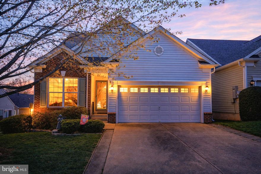 Falls Run, a Del Webb active adult community is the setting for this stunning 4-bedroom, 4-bathroom home which redefines the concept of "right-sizing." Spanning three finished levels, and offering over 4,000 sq. ft. this residence offers expansive living spaces that balance formal elegance with the warmth of open-concept design, perfect for both entertaining & comfortable everyday living.  This home has been professionally staged to enhance your private tour - be sure to check out the community center while you're here, too!

As you enter through the inviting center foyer, you'll find a sunny home office to your left, complete with built-in bookshelves ideal for showcasing your favorite books or treasured keepsakes. Continuing through the foyer, you are greeted by an open and airy living and dining space, beautifully accented by architectural accents that define each space. The row of sunny windows on the side of the home bathe the interiors in natural light, creating a warm and inviting atmosphere throughout. To the right, discover the first of the four bedrooms, perfect for guests seeking comfort and privacy, complemented by a conveniently located hall bath. The well-appointed laundry room, offering additional storage, provides easy access to the garage. At the heart of the home lies a well-designed kitchen, featuring a comfortable table space for informal meals plus a kitchen island for prep and service. 

The kitchen has been outfitted with custom cabinet pull-outs and shelving to make meal prep and entertaining a breeze. The spacious family room beckons with a cozy gas fireplace and sliding glass doors that lead to an outdoor deck, shaded by a newly installed awning for those sunny days, making it an ideal spot for relaxation or gatherings. Retreat to the back of the house where you'll find the roomy primary bedroom suite, boasting a large walk-in closet equipped with an organizational system. The en-suite bathroom is a masterpiece, remodeled to include dual vanities, an accessible shower with a built-in seat, and all the comfort you could desire for a rejuvenating experience. 

Ascend to the upper level, where a delightful guest suite awaits. This space features a spacious loft area ideal for relaxing or entertaining guests, along with a bright bedroom complete with ample closet space and a dedicated full bathroom for enhanced privacy. 

The lower level is a true entertainer's haven, highlighted by a large recreation room that extends out to a concrete patio. Here, you'll find a charming porch swing and a covered area that invites you to unwind with friends surrounded by nature. The fourth bedroom and an additional bath are conveniently located in this lower level, providing a private retreat for visitors. Adjacent to the recreation area is a complete bar outfitted for entertaining,  with a full bar setup and mini fridge that beautifully accentuate the space. The unfinished section of the basement offers abundant storage and utility options, perfect for seasonal decor, tools, and equipment.

Notable features include: Triple crown molding in formal rooms, recessed lighting throughout,  soft-close drawers and doors in the kitchen, a center island for prep and entertaining, elegant quartz countertops, ADA-compliant toilets, shower, and a convenient ramp in the garage for future mobility needs. As a resident of Falls Run, you'll enjoy more than just a beautiful home. The community is led by a full-time Lifestyle Director who curates a full calendar of programming catering to a wide range of interests. Explore the vibrant downtown Fredericksburg, just minutes away, where you'll find an array of boutiques, restaurants, scenic river walks, parks, grocery stores, medical offices, and essential services for your convenience.