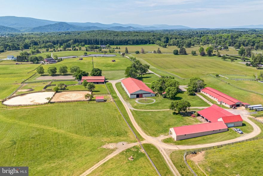Privacy and beautiful mountain views welcome you at this equestrian estate in Clarke County!  Located 11 miles from the Upperville Horse Show Grounds, 16 miles from Middleburg, 1 hour from Dulles Airport, 6 miles to L'Auberge Provençale, 1.8 miles to The Locke Store, and 5 miles from the Va State Arboretum.  This is a true Horseman's paradise filled with opportunity to live out your equestrian dreams with 3 outdoor arenas, an indoor arena, horse walker, oval breaking arena, 3 barns totaling 45 stalls, board fencing, and a charming farmhouse.  Each barn has its own office/lounge area with a half bathroom and feed room.  Enjoy both peaceful, expansive ride out with views of the Blue Ridge Mountains in the distance or riding year-round in the indoor arena with a beautiful viewing room.  The home has hardwood floors throughout, a deck, and renovated kitchen & bathroom. The property also includes a private detached office and a detached car garage for all your storing needs.  Future owners have the ability to build an additional homesite since the 51 acres is not in Conservation Easement. Call me today to experience living and fine dining in the beauty of our beloved horse country!
