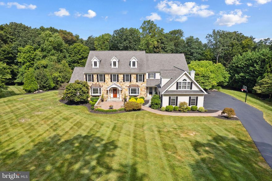 Malvern stunner with almost 6 acres of land on a private road that leads into a quiet, secluded cul-de-sac in Charlestown Township. New tax assessment for 2025 - cost savings of $6,000+ yearly! This breathtaking 5-bedroom Colonial offers a professionally epoxied 4-car garage, a custom, built-in mudroom for convenient storage off the garage, a beautifully updated eat-in kitchen with stainless steel Wolf appliances and a huge Sub-Zero fridge, a 1000+ square foot finished basement with space for an in-law suite or home gym, and a main level perfect for entertaining with crystal chandeliers, a sunroom filled with natural light, a formal dining and sitting room, and an over-sized family room with a gas fireplace!

As you enter through the grand foyer, hardwood floors, intricate millwork, and crown molding set a refined tone. Host memorable gatherings in the sophisticated dining room, complete with a tray ceiling, crystal chandelier, and ambient wall sconces. The adjacent butler’s pantry and walk-through bar ensure effortless entertaining, while the gourmet eat-in kitchen delights with bright cabinetry, quartz countertops, and high-end stainless steel appliances. The large island offers both additional prep space and seating, and the dining area seamlessly transitions to the impressive outdoor patio with built-in gas grill via sliding doors.

The inviting family room, featuring a vaulted ceiling and a striking fireplace with a wood mantel, serves as the heart of the home—a perfect retreat for cozy gatherings. This level also includes two convenient half baths and a dedicated home office with built-in shelving.

Up the sweeping staircase, the expansive primary suite provides a true sanctuary with a detailed tray ceiling, a serene sitting room complete with built-ins and a gas fireplace, two spacious walk-in closets, and two exquisitely designed full bathrooms. Four additional bedrooms, each offering ample closet space, and two well-appointed full bathrooms complete this level.

The finished basement is an entertainer’s dream, featuring a kitchen/bar, a spacious family/game room with a fireplace, and a full bathroom with a shower/tub combo. Sliding doors lead to the outdoors, where an expansive patio with a built-in grill awaits—ideal for al fresco dining and outdoor gatherings. Stairs leading from the basement to the 4-car garage add to the home’s functionality.

Set on almost 6 acres of professionally landscaped grounds, this residence offers a private oasis for outdoor enjoyment and relaxation. A short walk brings you to Brightside Farm Park to enjoy hiking and walking on paved paths through the woods. Recent 2024 updates (totaling $300,000) include full stucco remediation and installation of Hardie board with a transferable 5-year warranty, new 6-inch gutters, new carpeting, and fresh interior paint, ensuring this home is move-in ready and impeccably maintained.