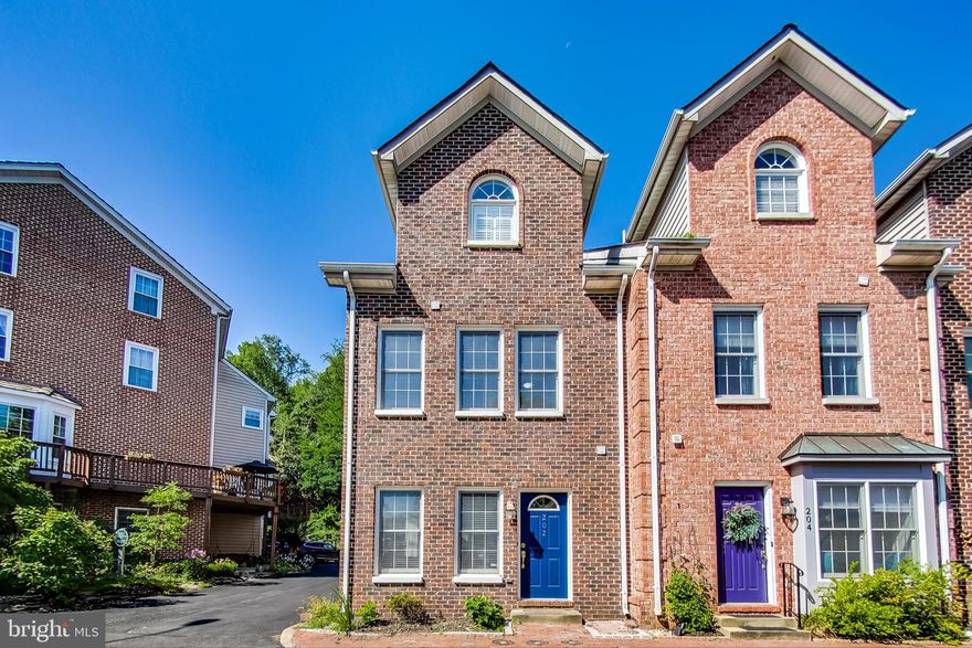 Don't miss out on this opportunity in Historic Downtown Occoquan! Live your idyllic life and walk to area shops and restaurants along the peaceful Occoquan River. This updated end unit townhome has three splendid levels, all freshly painted with neutral colors throughout.

The main level is wide and open, with a dual-sided gas fireplace separating the spacious living area and eat-in kitchen. Kitchen cabinets have been resurfaced with crisp white, brightening up the kitchen with granite countertops and stainless steel appliances  that have been updated over the last few years. The dining space walks out to a private patio that backs to a serene garden space and conservation area. Recently refinished hardwood floors can also be found throughout the main level and there is a powder bath on this level for your guests' convenience.

The 2nd level of the home features two bedrooms, one partial en suite bathroom and a laundry center/utility room. Both bedrooms are roomy and can accommodate a traditional bedroom set. On the third level, is the premier suite. Expansive bedroom with vaulted ceilings, a private walk-out balcony and an oversized en suite bath with dual vanities, a large soaking jetted tub and a separate shower stall. The primary suite also features dual closets, a linen closet and an "attic" storage space.

Other bonuses? The home has two reserved parking spaces in the lot directly behind it and this community enjoys incredibly low HOA fees at just $25 a month. Enjoy this quaint but modern neighborhood just steps from local favorites like The Secret Garden Cafe and The Spot on Mill Street.