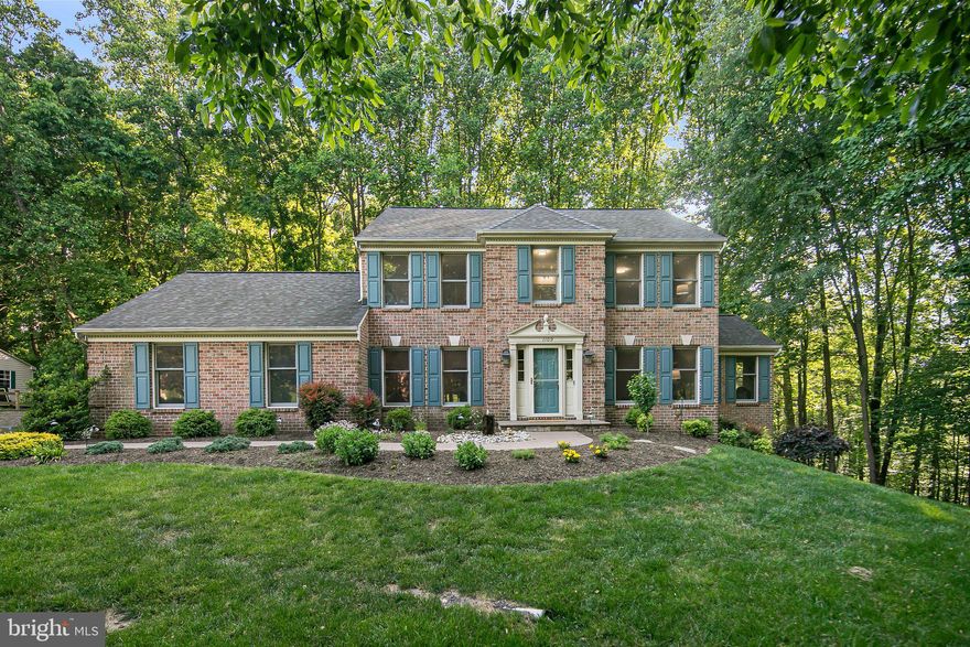 Hurry to this stately colonial tucked into the coveted Hammonds Estates neighborhood.  This beautiful home offers the classic charm of formal living spaces with the modern feel of an open layout between the kitchen and the great room.   As you enter to the gleaming hardwoods floors you are welcomed by the luxurious feel of upgraded finishes and natural light.   The kitchen offers newly installed quartz counters and a tranquil view of wooded back yard.  You then enter the great room with vaulted ceilings and an elegant fireplace.  As a bonus on the main level, the den off of the great room provides an opportunity for a home office/ hobby room, extra living space, or the potential to have a main level sleeping area.  The upper level offers large bedrooms with updated bathrooms.  The primary suite provides a private and spacious feeling that is connected to the on-suite bathroom with a double-sink vanity that has a new counter top.  The lower level offers an open layout that includes multiple living areas, storage options, and a full third bath.  It also includes walkout access.  As if the immaculate interior isn't enough, the exterior and the lot steal the show on this listing.  With over an acre of land and the fact it is nestled in at the end of a non-passthrough street, you will have all of the privacy you could ask for while still getting the benefits of a neighborhood atmosphere.  This well-manicured lot offers an oversized 2-car garage, a spacious front yard, tons of outdoor living space with a deck off of the main level and an upgraded patio space off of the lower living level.  Backing to a serene forest view with extensive hardscapes throughout so the views can be fully enjoyed provide an unmatched feeling from any other property on the market.    The location includes the desirable Liberty High School District and great access to major commuter routes that easily connect to Ft. Meade, Baltimore, or Washington DC.  Great proximity to outdoor spaces such as Piney Run Park or the Liberty Reservoir and shopping/dining options. NE facing home.