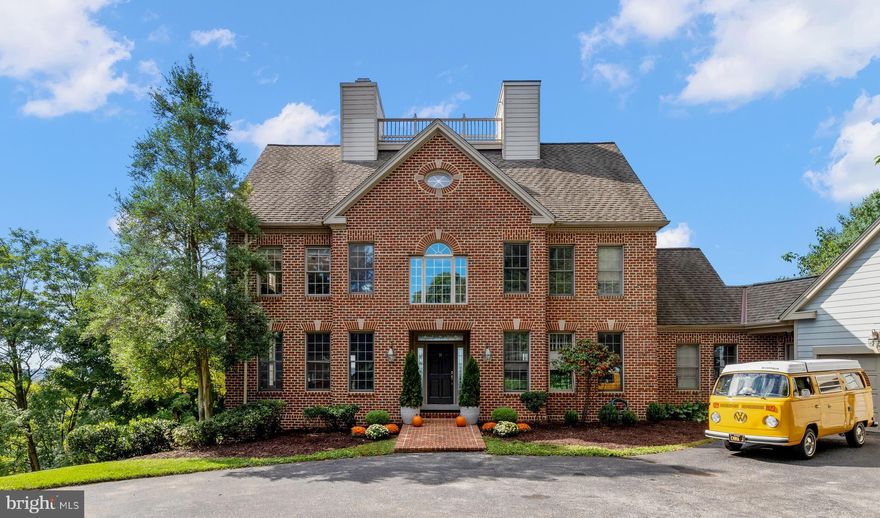 SUBSTANTIAL PRICE ADJUSTMENT!  This extraordinary custom-built Georgian brick home with attached 2 car garage is located in the coveted Hillside at Seminary development.  The property is desirably situated in a cul-de-sac on a lovely 1-acre lot with gorgeous trees and plantings.  The residence exudes an incredible sense of sophistication, design, style, and attention to detail. The owners have made significant renovations to the property using upscale materials and designer finishes. Main level features include a dramatic two-story foyer with marble floor and dramatic staircase, an eye-catching and sun drenched two-story great room with Palladian window and wood burning fireplace perfect for entertaining or casual relaxation, and lovely sitting room which adjoins the striking dining room with detailed moldings and wainscotting.  The newly updated gourmet kitchen is a chef’s dream with its expansive cooking island, a multitude of cabinetry, high-end stainless-steel appliances, fabulous Quartz countertops, an amazing large pantry and generous-sized eating area with cathedral ceiling and skylight.  A refurbished lovely full bath is perfect on the main floor and can be accessed from the kitchen area, mud room, and side door entry. The second level is fully dedicated to the primary en-suite bedroom with sitting area, fireplace, multiple closets, ideally located laundry room, and a newly renovated sumptuous bath with free-standing tub, separate shower, and double sink vanity.  The top floor of the residence is perfect for two additional bedrooms and an office/sitting room.  The lower level has two bedrooms and two full baths as well as an expansive family room with wet-dry bar.  The basement, which has been finished, can be accessed from the rear ground level and is perfect for extra storage.  Additional enhancements and features of the property include  custom designed elevator to all levels, gorgeous wood flooring throughout, central vacuum, crown moldings, and many door designs – Atrium, French, Insulated, Six Panel – window features – double pane, insulated, Low-E, and Palladian, and an architectural shingled new roof with remaining 35 yr.  warranty.   There are 11 decks/balconies on the rear/side of the home and can be accessed from most rooms throughout the house.  The expansive scenic views toward the east, south, and west from many windows, decks, and the Widow’s Walk at the roof are spectacular. The loft above the oversized two car garage is perfect for additional storage. Plumbing rough ins for additional baths are located on third top level and in basement.   The circular driveway can accommodate a multitude of additional vehicles.  There home has natural gas; there are three heating and cooling zones and a gas tankless water heater.  The property is desirably located close to public and private schools, universities, shopping centers, restaurants, country clubs, hospital campuses and major highways. This stunning home is turn key ready for new owners to enjoy!