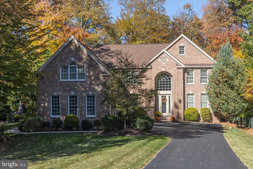 A meticulous home tucked back on a cul de sac in a wonderful neighborhood setting. This brick and Hardie plank residence showcases wonderful space with fantastic windows highlighting nature views from every room and offers something for everyone. Gorgeous hardwoods span the first level with a neutral tone that works with every décor. An expansive Gourmet Kitchen featuring high-end appliances and walk-in pantry is open to the 2 story Great Room with wonderful, coffered ceiling, walls of windows and gas fireplace for those chilly nights. 4 expansive bedrooms on the upper level with each one offering walk-in closets! The walk-out Lower Level is finished to include extra living space yet still provides ample storage. The extensive paver patio wraps around the home and is embraced by a wooded backdrop offering the utmost in privacy while enjoying the outdoors. Additional amenities include a convenient chandelier lift, 3 car garage outfitted with epoxy floors and storage cabinets, central vac, Dining Room with built-in serving area, 3 zone HVAC, gas hook-up for a BBQ grill and lawn irrigation system. Tremendous value in the highly desired Central Bucks school district and conveniently located between Doylestown, Newtown and New Hope. Simply move-in and enjoy!