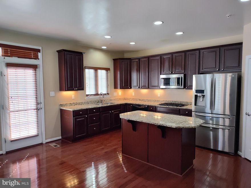 Gorgeous 3 -Level Townhouse ! Bright and Sunny end unit with 3 Br. / 2.5 Ba., upper floor master / and main stove for another master bar with loft,  large Kitchen with huge Island, Granite and Stainless Steel Appliances. Hardwood Floors on the main level and throughout.  Lots of storage spaces, Large Deck off Dining Room, with a long with the Freshly Painted room , 2 Car garage off of Laundry Room. Close to major routes, BWI / Fort Meade / NSA, & Shopping / walk next door to Merritt Athletic Club and more!