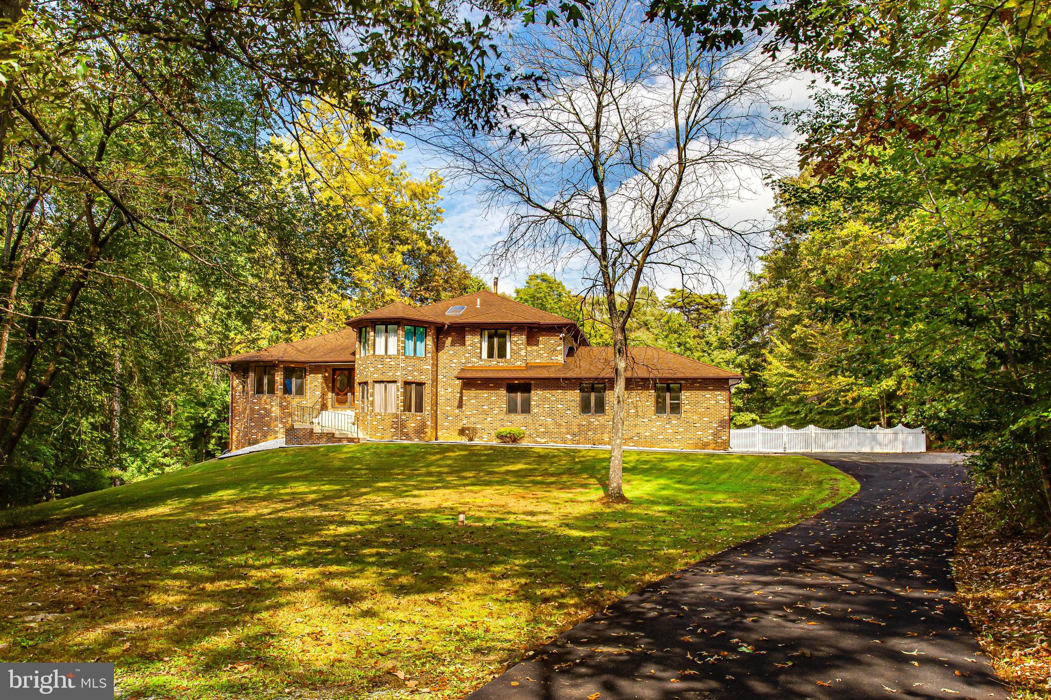 One of a kind contemporary home with style and space on nearly 6 acres! Discover a private drive framed by lighted brick pillars that leads to this beautiful custom estate. This stunning home features 4,000+ square feet of living and entertaining spaces with 4 levels. Grand foyer opens to dramatic 2 story ceilings, light filled space, large skylight and gleaming hardwood floors. This home has the perfect combination of open entertaining areas with separate "formal" rooms with plenty of windows to bring in the outside light and views of the tree lined lot! The oversized windows and soaring ceilings with skylights flood the home with light that adds an airiness to its already open floor plan. High-end finishes and thoughtful selections throughout make this the ideal sanctuary for everyone to work, learn, relax and play. Gourmet kitchen features a double oven, cherry cabinets, cooktop, stainless steel appliances, island and space breakfast area. Spend time year round in the huge sunroom with walls of windows that capture the entire view of the backyard. Spacious sunken family room is impressive with cozy brick fireplace, French doors, built-ins and bar. Game room features a pool table and wet bar. For more formal occasions, there is a separate dining room and living room with soaring ceilings and plenty of space to host a gathering. Great entertainment flow inside and outside featuring indoor/outdoor living with walkouts from dining room, sunroom and family room, leading to exterior multi-level decks overlooking the spacious fenced private yard. The upstairs will continue to impress you! Primary bedroom suite will impress you with a sitting area, 3 closets (2 walk-in), spa-like bathroom features an oversized jetted tub, dual vanity, newly renovated shower with glass shower door, gorgeous wall tile and penny tile floor. There's plenty of space to rest and relax. Upper level also includes 2 generously sized bedrooms, laundry, and updated bathroom. 4th bedroom is located on the main level. Enjoy the outdoors with multiple outdoor spaces and an incredible yard space for a private pool, this home offers the elevated indoor/outdoor lifestyle you've been looking for! Updates include: new gutters and downspouts, roof (about 15 years old with 50 year shingles), new sliders in dining room and more! This stunning custom-built property features a perfect blend of traditional and contemporary finishes for the most discerning buyer. Close to shopping, restaurants, grocery stores, library, hiking/biking trails and University of Maryland Charles Regional Medical Center. Enjoy golfing at the White Plains Regional Golf Course, ice skating or rock climbing at the Capital Clubhouse, exploring local wineries and breweries or catch a minor league baseball game at the Blue Crabs Stadium. Conveniently located to Joint Base Andrews, Pentagon, Bolling, MD-5, I-495 Beltway, Washington, DC, Virginia, commuter bus lots and Branch Avenue Metro station.
