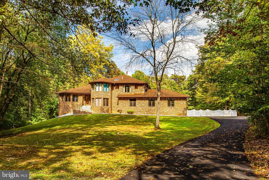 One of a kind contemporary home with style and space on nearly 6 acres! Discover a private drive framed by lighted brick pillars that leads to this beautiful custom estate. This stunning home features 4,000+ square feet of living and entertaining spaces with 4 levels. Grand foyer opens to dramatic 2 story ceilings, light filled space, large skylight and gleaming hardwood floors. This home has the perfect combination of open entertaining areas with separate "formal" rooms with plenty of windows to bring in the outside light and views of the tree lined lot! The oversized windows and soaring ceilings with skylights flood the home with light that adds an airiness to its already open floor plan. High-end finishes and thoughtful selections throughout make this the ideal sanctuary for everyone to work, learn, relax and play. Gourmet kitchen features a double oven, cherry cabinets, cooktop, stainless steel appliances, island and space breakfast area. Spend time year round in the huge sunroom with walls of windows that capture the entire view of the backyard. Spacious sunken family room is impressive with cozy brick fireplace, French doors, built-ins and bar. Game room features a pool table and wet bar. For more formal occasions, there is a separate dining room and living room with soaring ceilings and plenty of space to host a gathering. Great entertainment flow inside and outside featuring indoor/outdoor living with walkouts from dining room, sunroom and family room, leading to exterior multi-level decks overlooking the spacious fenced private yard. The upstairs will continue to impress you! Primary bedroom suite will impress you with a sitting area, 3 closets (2 walk-in), spa-like bathroom features an oversized jetted tub, dual vanity, newly renovated shower with glass shower door, gorgeous wall tile and penny tile floor. There's plenty of space to rest and relax. Upper level also includes 2 generously sized bedrooms, laundry, and updated bathroom. 4th bedroom is located on the main level. Enjoy the outdoors with multiple outdoor spaces and an incredible yard space for a private pool, this home offers the elevated indoor/outdoor lifestyle you've been looking for! Updates include: new gutters and downspouts, roof (about 15 years old with 50 year shingles), new sliders in dining room and more! This stunning custom-built property features a perfect blend of traditional and contemporary finishes for the most discerning buyer. Close to shopping, restaurants, grocery stores, library, hiking/biking trails and University of Maryland Charles Regional Medical Center. Enjoy golfing at the White Plains Regional Golf Course, ice skating or rock climbing at the Capital Clubhouse, exploring local wineries and breweries or catch a minor league baseball game at the Blue Crabs Stadium. Conveniently located to Joint Base Andrews, Pentagon, Bolling, MD-5, I-495 Beltway, Washington, DC, Virginia, commuter bus lots and Branch Avenue Metro station.