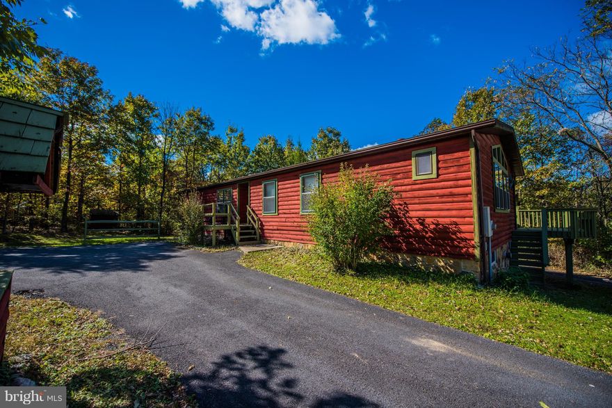 Beautiful home & location on 5.36 tucked away acres in the trees. Features log siding, endless deck to enjoy the sunsets and the views.This 3 BR 2.5 BA home has lots of open inviting living space for the family with Rec room & Family/Sun room. Also 2 car garage & detached garage.Call me and make an appointment to tour this fabulous home right away. Sellers offering $5000.00 towards closing cost.