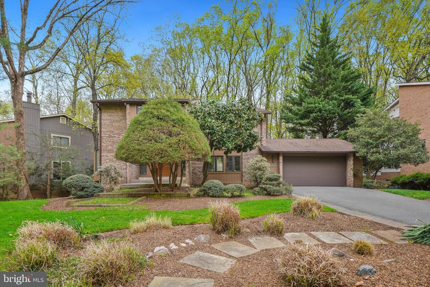 Welcome to 8601 Carlynn Drive a freshly painted Mid Century Modern split level with six bedrooms, four bathrooms and a two car garage. Step inside and notice the multiple large windows flooding the home with natural light! The eat in kitchen is equipped with stainless appliances including a brand new range and refrigerator. Continue on into the dining room that opens to the living area complete with Cathedral ceilings and a view of the private wooded back yard. Down to the next level you will discover the family room that includes access to the back deck, a bedroom and full bath. The next level up is where you will find three spacious bedrooms and a hall bath. The owner's suite is the next level up  complete with multiple closets, a spa inspired bath. This level also includes a home office space. The bottom floor has a giant recreation area, laundry, storage, a bedroom and another full bath. Set in a park like setting just minutes to shopping, restaurants and 495 with easy access to VA and DC, this house is your perfect new home.