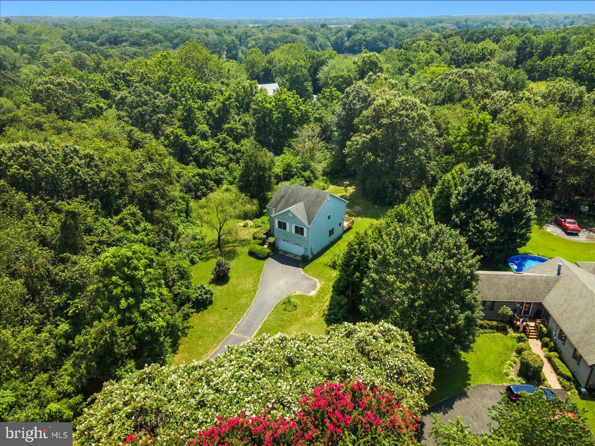This 3 bedroom, 2.5 bathroom house is set on over an acre of healthy meadowland in a small neighborhood. The home features an inviting foyer and living room, hardwood floors, enormous windows, and large bedrooms. A large back deck and sunny yard provide great opportunities for outdoor play, cultivating gardens, and small-scale home-steading. There is no HOA, giving the next owner free reign to let their imagination run wild in the outdoor spaces!
Entering the house from the front porch, the high ceilings of the foyer create a welcoming sense of open-ness. The sunroom adjoins the living room, and enjoys a wide view of the back deck and back yard. The kitchen sits comfortably between the sunroom and the dining room, and the large window in the dining room allows even more natural light to fill the first floor.
Upstairs, there is a large primary bedroom with double doors, and an attached bathroom. The attached bath features a double vanity, a beautiful free-standing tub, and a shower stall as well. The second bedroom is similarly large, and features a separate entry to the hall bathroom, allowing it to be set up as an en-suite bathroom if desired. The third bedroom features a walk-in closet that connects to the small balcony overlooking the foyer. The washer and dryer are conveniently located on the upper floor as well.
The 2 car attached garage offers convenience and additional storage space with extensive shelving.
This property is located less than a 5 minute drive from St. Mary's College of Maryland, local marinas, Historic St. Mary's City, and wooded trails, and less than 15 minutes from PAX NAS, Webster Field, grocery stores, a large farmer's market, Point Lookout State Park, and Elms Beach. If you are hoping for a small neighborhood, removed from congestion, but within range of amenities, this home may be the perfect fit.