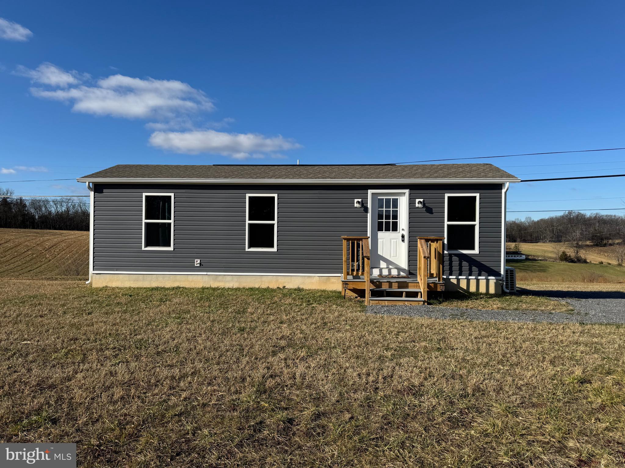 Highest and best offers due by 5PM Tuesday, February. 18th. Discover your perfect retreat in this brand-new 1-bedroom, 1-bath tiny home. Nestled on 1.4 acres of serene countryside, this cozy property offers stunning mountain views and a private rear deck overlooking picturesque rolling hills. Enjoy the tranquility of a rural setting while being just minutes away from the charm and history of downtown Berkeley Springs. Compact yet thoughtfully designed, this home is ideal for those seeking simplicity and natural beauty. 3 bedroom septic allows for future improvements. Lease may be considered.