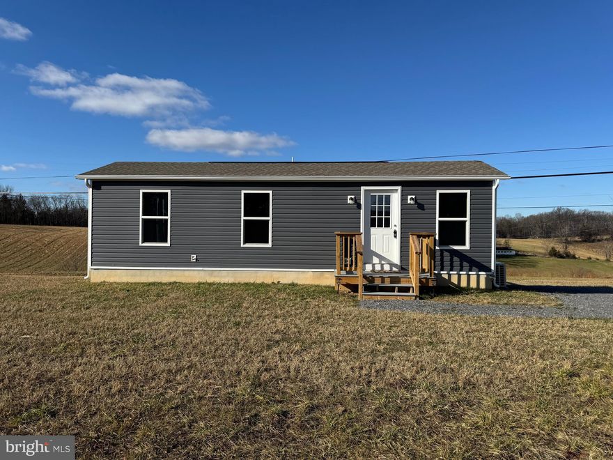 Highest and best offers due by 5PM Tuesday, February. 18th. Discover your perfect retreat in this brand-new 1-bedroom, 1-bath tiny home. Nestled on 1.4 acres of serene countryside, this cozy property offers stunning mountain views and a private rear deck overlooking picturesque rolling hills. Enjoy the tranquility of a rural setting while being just minutes away from the charm and history of downtown Berkeley Springs. Compact yet thoughtfully designed, this home is ideal for those seeking simplicity and natural beauty.  3 bedroom septic allows for future improvements. Lease may be considered.