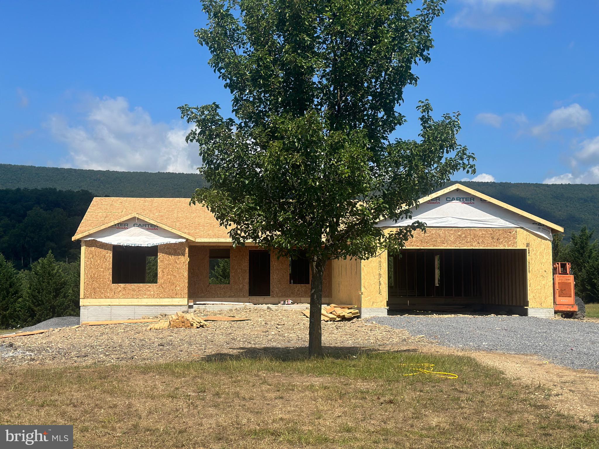 New construction home located in the beautiful sought after Cacapon South. This is a ranch style home with a stone front garage & partial stone front, sitting on over an acre surrounded by beautiful mountain views. Featuring the popular split bedroom design. Vaulted ceilings in the open concept main level with granite countertops in the kitchen, Kitchen Island, walk- in pantry. 3 Bedrooms & 2 Full bathrooms. The primary bathroom has double sinks with granite top and a make up vanity, stand alone tile shower, & free standing soaking tub. Enjoy a cup of coffee on your rear deck on these soon to be chilly nights. Garage is a 24X 24! The laundry room/mud room off the garage is the perfect drop off station for your kids backpacks, groceries, or even store your pets needs! Cabinets in laundry room with granite top. The unfinished basemen & rough in plumbing for a bathroom t leaves room for future expansion. A few steps out your basement leads you to your beautiful mountain views. Cacapon State park is 0.3 Miles away. Park, Beach, walking trails, fishing, & so much more. You don't want to miss this one! Estimated completion date is Early- Mid November, just in time for the Holidays.