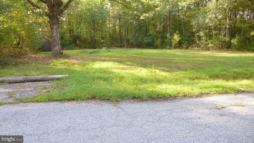 CLEARED LOT on a paved road. Enjoy living in this quiet community that's walking distance to the  shopping center with a grocery store, pharmacy/drug store, gift shops, restaurants and more.. The sandy beach, boat ramp, community fishing pier,  and play grounds are only a few blocks away from the Town.  Public water and sewer hook-ups are available. Bring all offers. Make the call today.