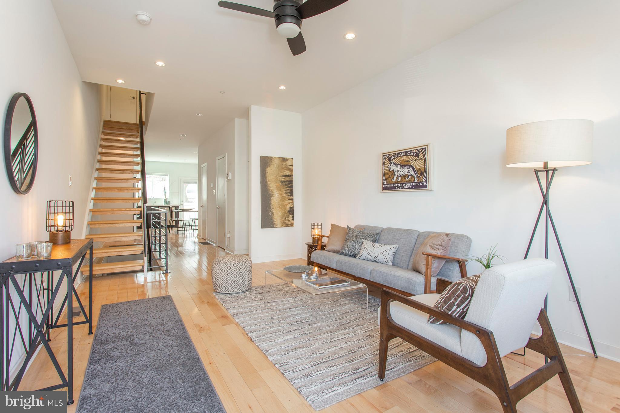 This six-years-young home has all the appeal of new construction with the warmth of a home. Timeless design keeps it on trend and pride of ownership keeps it like new. The blond hardwood floors, blank-slate white walls and timeless finishes are the perfect canvas for any homebuyer to add their personal style. Floating stairs combined with an open first floor create a bright and airy living area with clear sight lines back the L-shaped eat-in kitchen. Espresso-hued Shaker-style cabinets pop against the white subway tile backsplash paired with white quartz countertops that offer prep space for days. When weather allows taking the party outside, a large deck awaits out back, ready for your patio table, grill and lounge furniture. (Cornhole, anyone?) The bright and breezy vibe continues upstairs with two bedrooms; both are spacious with large windows, recessed lighting and deep closets--and the rear bed has two. In between is a laundry closet with stackable LG frontloaders and bonus space for storage. The bathroom on this floor has an extra-wide walk-in shower, ceramic tile floors and shower surround and pretty floating wood vanity. The third floor is entirely devoted to the master retreat; a spacious bedroom, walk-in closet and spa-like bathroom with dual vanity, deep soaking tub and humongous walk-in shower with frameless glass door. You'll want to enjoy the rooftop deck in all weather, with its 360-degree views, including the Center City skyline. The basement is the true hidden gem of the home. Yes, it provides storage and added living space but the unique layout and concrete walls give a true sense of privacy creating a secret hangout space. Use the wall of open shelving for a library, or maybe a bar for your own personal speakeasy. This home is on a nice wide block in an ideal Fishtown location, with local faves like Memphis Taproom, Loco Pez and Green Eggs Cafe within a few blocks.