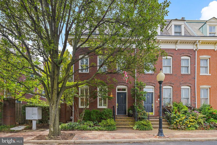 Welcome to 312 N Fairfax!  A sophisticated brick end townhome with uncompromising quality.   Almost 2900 sq ft.  Located in a cul-de-sac off  N Fairfax Street and a mere 3 blocks to King  St and 2 blocks to the Potomac River. This hidden enclave of homes offer both privacy and convenience plus 2 assigned parking spaces steps from your front door. Enjoy the outdoors and entertaining on the stone patio with fountain and gas ready for your grill.  Built in 1998, this home offers high ceilings, custom trim work,  exquisite built-in cabinetry and closets, chefs kitchen with gas Wolf range, Waterworks kitchen and bath fixtures plus spacious bedrooms and baths.  
Hardwood floors on the main and upper levels. New carpet just installed in lower level media room and sisal in the 2nd and 3rd bedrooms.  The stunning kitchen opens to the family room w/ fireplace  with french doors that lead to the stone patio.  Designer light fixtures in the dining room and main floor powder room will convey.  The primary suite encompasses the entire 2nd floor.  Luxurious built-ins and custom closet for two .  Step into the expansive primary bath with double sinks, tub and oversized shower plus private lavatory.
The upper level offers 2 spacious bedrooms and a full bath.  Each bedroom with an abundance of natural light with rows of windows.  Each bedroom will accommodate furniture and desks for those working from home.  A convenient laundry center and skylight  are in the hallway. 
The lower level is the perfect media and recreation room.  It has a full bath with steam shower, a well appointed wet bar and large storage room.  A great place for Sunday football gatherings! 
This beautifully appointed home  with its modern flare is a rare find particularly at this close in location.