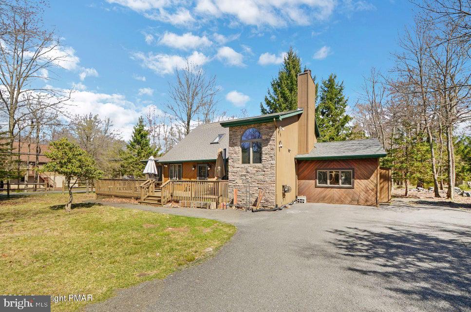 $10K Carpet Credit! Spacious 4 bedroom, 2 bath Pocono vacation home nestled just 2 blocks from the lake in exclusive Lake Harmony Estates, which offers a private beach, tennis courts, & rare lake access for your renters too! New Central Air installed 2022 (except 1 bdrm & game rooms) & Hot Tub 2021! The expansive living room boasts floor-to-ceiling stone fireplace, plush carpeting, and leads to the huge game room/media room. The bright kitchen has plenty of oak cabinets, updated appliances, peninsula island for bar stool seating for your guest, gleaming Pergo floors, and leads to the dining room! Jack Frost/ Big Boulder is within walking distance, as well as boating, hiking, dining and hours of family fun! The large deck with picnic table offers plenty of options for outdoor socializing.