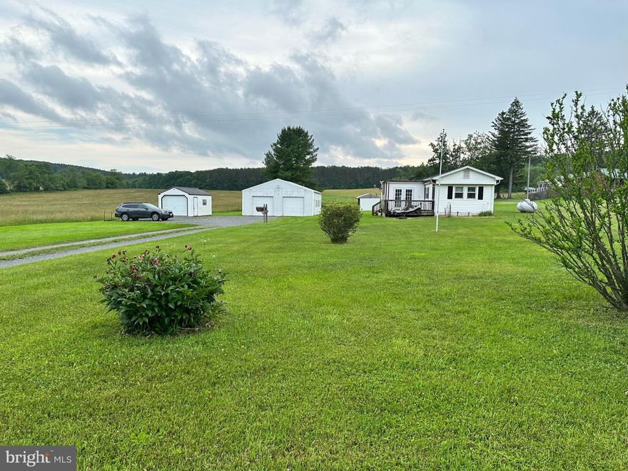 Whether you want your weekend get-away only minutes from Deep Creek Lake and WISP, or to build your dream home close to everything the lake and ski resort have to offer, you won't want to miss this perfect opportunity. Live in the manufactured home that is there while you build your new one or just fix it up for the perfect place close to all the fun! Don't forget about the fabulous 2 car garage/workshop to use for so many possibilities. On over an acre of land, you don't have to worry about being on top of neighbors either.