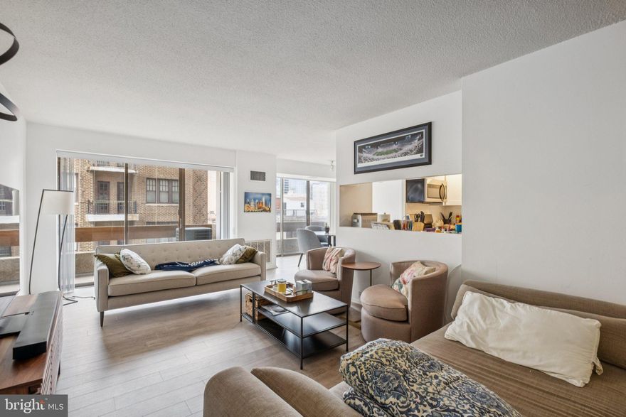 Updated two bedroom, two bathroom with French balcony and Center City views from all rooms at Center City One.  This spacious residence boasts beautiful natural light and skyline views from oversized windows, modern updates throughout, and a split floorplan offering generously sized rooms, perfect for everyday living and entertaining. Enter into the expansive great room featuring a large living room with access to a private balcony, ideal for enjoying a morning cup of coffee, and separate open dining area with access to its own Juliet balcony. Adjacent is the fully updated kitchen with white shaker cabinetry, quartz countertops, white subway tile backsplash, stainless steel appliances, recessed lighting, upgraded tile floor, and breakfast bar with passthrough overlooking the living room. The spacious primary bedroom has a walk-in closet and an updated ensuite bathroom with white vanity, glass-enclosed stall shower with subway tilework, and upgraded tile floor. The second bedroom enjoys a wall of closets, nearby walk-in closet, and use of an updated full hall bathroom with white vanity, glass-enclosed tub shower with subway tilework, and upgraded tile floor. Additional highlights include a laundry closet with side-by-side washer and dryer and gray vinyl floors throughout. Residents of Center City One enjoy a 24 hour doorman, on-site management, an attached parking garage (parking is an additional monthly fee, subject to availability), premium location along the Avenue of the Arts, and the convenience of ground floor retailer including a dry cleaner and convenience store. Located steps from the Avenue of the Arts and just a few short blocks from both Washington Square and Rittenhouse Square, Center City One is literally in the heart of Center City, providing easy access to many of Philadelphia's best restaurants and retailers, the main office corridors, and public transportation.