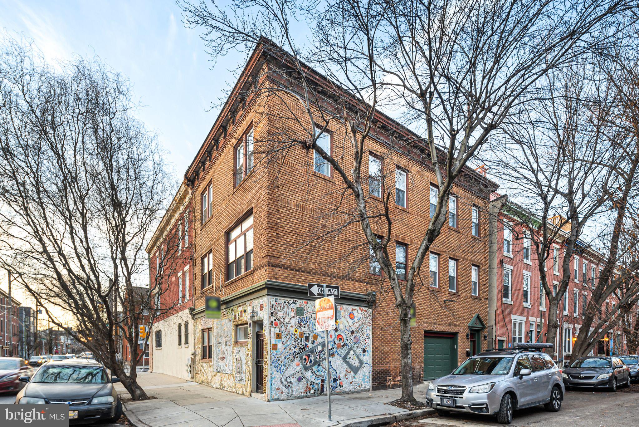 Discover 1035-37 Bainbridge Street! This rare and versatile multi-family building is located in Philadelphia’s sought-after Bella Vista neighborhood, bordering Washington Square West. The A-unit side of the building offers a unique dual-unit layout combined with garage parking, perfect for multi-generational living or rental income potential—all while maintaining modern city luxury. This adaptable property features two distinct living spaces, plus an additional garage and a lower-level den/entertainment area. It’s an ideal opportunity for homeowners seeking flexibility, investors looking for income-producing rentals, or families desiring a private suite. Spanning multiple levels, the A-unit can function as either one spacious home or two separate units. The largest upper unit boasts two bedrooms and two bathrooms, along with a well-appointed kitchen and dining area. The spacious primary bedroom features an ensuite bathroom, skylight, seating area, and dual closets with built-in organization systems. The second bedroom is bright and airy, with stunning floor-to-ceiling white built-ins, and is conveniently located across from a laundry closet equipped with a brand-new side-by-side washer and dryer. The second full bathroom is fully updated and features a jacuzzi tub and shower. A cozy living room with a fireplace sets the perfect ambiance for relaxing evenings. The fully updated kitchen is equipped with high-end stainless steel appliances, white quartz countertops, and two-tone modern cabinetry. All living spaces have access to a private deck with breathtaking, unobstructed city skyline views! The lower-level unit provides a separate living space, complete with a Murphy bed, full bathroom, modern kitchen, and a home office or flex space—ideal for extended family, long-term tenants, or Airbnb potential. Below, a fully finished basement offers even more possibilities, perfect for a home gym, movie theater, or additional den space. Another full bathroom is also located on this level. Completing the A-unit is a private garage with hand-painted floors, offering secure parking in the heart of the city. The B-unit has a completely separate entrance and does not share common space with the A-side. Upon entry at street level, you'll step into a large open-concept kitchen, living, and dining area featuring refinished hardwood floors and abundant natural light. The kitchen boasts dark granite countertops, modern honey-colored wood cabinetry, and stainless steel appliances. The first floor includes a fully updated bathroom with all-new tile, a shower, and a vanity. Upstairs, the second floor offers two spacious bedrooms, each with large floor-to-ceiling double-door closets. Both bedrooms receive ample natural light and can accommodate king-size beds. The second-floor bathroom features a tub and tiled shower, while a full laundry closet with a side-by-side washer and dryer is conveniently located just outside the bedrooms. The bi-level unit also includes a large private basement, providing extra space for storage, a media room, a playroom, or an entertainment area. Designed with style and functionality in mind, this home has been fully updated and is move-in ready. A unique highlight of the property is its direct connection to Philadelphia’s famous Magic Gardens, featuring an original Isaiah Zagar mosaic art piece! With a Walk Score of 95, this location is a walker’s paradise, allowing for daily errands to be completed on foot. It also boasts a perfect Transit Score of 100, ensuring access to world-class public transportation. With easy access to public transit, I-95, and major highways, this Bella Vista gem is a rare opportunity to own a versatile property in one of Philly’s most desirable neighborhoods.