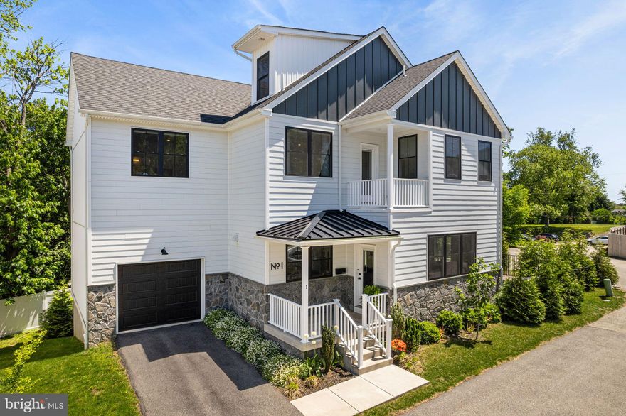 Welcome to Leverington Place – where high-quality construction meets thoughtful design in one of Roxborough’s most desirable new enclaves. This beautifully maintained, 4-bedroom, 4.5-bathroom single-family home was the original model residence, boasting top-tier upgrades and refined finishes throughout. With 6 years remaining on the 10-year property tax abatement, this home presents an outstanding opportunity for both luxury and value. Step inside to an inviting foyer that opens into a spacious, open-concept living area with soaring ceilings and wide-plank oak hardwood floors. The light-filled living room flows seamlessly into the chef’s kitchen, equipped with KitchenAid stainless steel appliances, timeless white shaker cabinetry accented with matte black hardware, calacatta quartz countertops, a full-height seamless backsplash, and a large center island perfect for both prep and entertaining. The adjacent dining area opens through sliding glass doors to a side porch leading to the private gated side/rear yard—ideal for pet owners or outdoor dining. The home features a custom mudroom with built-in cubbies, a coat closet, and a powder room, all leading to the oversized 1-car attached garage and private driveway. Upstairs, the second level offers three generous bedroom suites. The spacious primary suite includes a private step-out balcony, an expansive custom walk-in closet, and a spa-like bathroom featuring a freestanding soaking tub, step-in shower, double vanity, separate water closet, and linen storage. A full-size laundry room with side-by-side washer and dryer, laundry sink, and built-in cabinetry adds convenience. The third floor offers flexibility with a fourth ensuite bedroom—perfect for guests, a home office, media room, or gym. The partially finished lower level adds approximately 500 square feet of bonus living space ideal for a playroom, den, or home studio with the unfinished section allowing for the mechanics of the home and tons of storage space. Since purchasing the home, the current owners have made tasteful updates including upgraded window treatments, lighting fixtures, as well as adding additional fencing and landscaping, reflecting the care and pride of ownership throughout. Situated just a short walk to Ridge Avenue’s shops and restaurants, public transportation, and the scenic Wissahickon trails, with easy access to Center City, Chestnut Hill, the suburbs, and major highways—this home combines luxury living with everyday convenience.