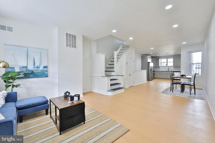 Welcome to this fantastic three-bedroom, one-and-a-half-bathroom home located on a well-maintained block in the desirable neighborhood of Point Breeze. As you approach the property, you’ll be greeted by a south-facing covered porch that invites you to unwind and sip your morning coffee. Step inside, and you'll discover an open concept and capacious living space. The living room is bathed in natural light with plenty of space to host family and friends. The dining space seamlessly connects to the updated and modern kitchen, which is sure to impress any home chef. Here, you’ll find top-of-the-line stainless steel appliances, 6 burner gas range, dishwasher and garbage disposal, alongside stunning granite countertops. On this level you will also find a conveniently located half bath. Off of the kitchen is a cozy and quaint backyard, great for a cafe table and chairs along with a small grill for summer fun. As you make your way to the second floor, you’ll find three comfortably sized bedrooms that offer ample storage and natural light, creating cozy retreats for rest and relaxation. The contemporary bathroom features a glass vessel sink, a deep soaking tub, a shower body panel and built in shelving for additional towels and toiletries. In the lower level you will find the laundry along with ample storage options. The high ceilings give flexibility to this space that can be transformed into a great workout area.  This home truly stands out with its roomy and inviting atmosphere, brand new flooring throughout, central air and heat and can come fully furnished. Move right in and immerse yourself in the perfect blend of tasteful modern updates while being steps away from Point Breeze Ave, restaurants and convenient public transportation to Center City. Only first month's rent and security are required for move in.