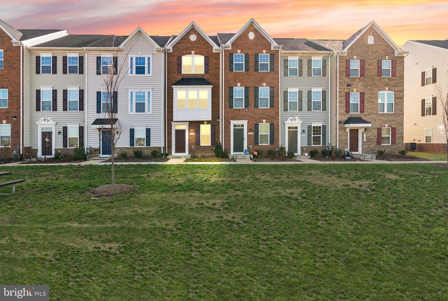 Welcome to this beautifully maintained, freshly painted northeast-facing townhome located in the sought-after Arcola Town Center community. Built in 2022, this Hepburn model by Ryan Homes offers 1,830 finished square feet across four levels of thoughtfully designed living space, featuring over $40,000 in builder upgrades, and the peace of mind of a 10-year structural warranty. This spacious home features 3 bedrooms and 4 full bathrooms, including a convenient main-level bedroom and full bath—each bedroom with its own en suite bathroom—providing flexibility and comfort for modern living. A versatile loft on the third level offers the perfect space for a home office, guest area, or additional living space. Well-maintained LVP flooring greets you at the front doorway and continues throughout the second-floor kitchen and living room. The gourmet kitchen is the heart of the home and also offers eat-in space, showcasing white cabinetry with brushed nickel hardware, granite countertops, a classic white subway tile backsplash, and a large center island with additional storage. Premium GE Profile stainless steel appliances include a 5-burner gas range with griddle, convection oven with air fryer and WiFi capability, microwave with convection cooking, dishwasher, and a refrigerator with water and ice dispenser. A pantry and recessed lighting complete this stylish and functional space. Enjoy seamless indoor-outdoor living with a 14x7 Trex deck located just off the kitchen, perfect for entertaining or relaxing. The bay window adds extra light and space to the living room. The home features LED lighting, ceiling fans, and Google Nest thermostats, along with two HVAC systems for enhanced comfort. Beautiful craftsman-style upgraded doors throughout. The primary suite offers a tray ceiling and a luxurious en suite bathroom with dual shower heads in a Roman-style shower and cultured marble countertops. Additional highlights include a brick front exterior, an oversized one-car garage and driveway, attic and garage storage, and a stackable LG washer and dryer with electric hookup. Located in a vibrant community with exceptional amenities including a pool, kiddie pool, clubhouse with gym and party room, multiple tot lots, dog park, and scenic walking trails. Enjoy ultimate convenience with walkability to Dulles Landing Shopping Center, featuring Target, Walmart, Dunkin’, restaurants, and nearby daycare. Ideally situated just 9 miles from Dulles International Airport.