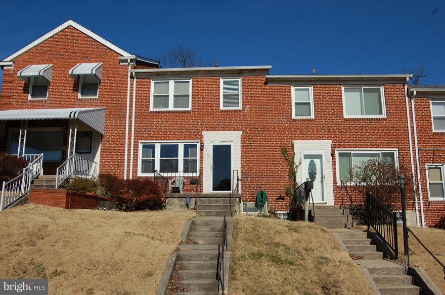 BRIGHT Townhome With Southern Exposure, 2 Full Baths (That Includes 1 In The Basement) And A Fenced Backyard With A 2 Car Parking Pad That Backs To Trees & Open Space. Updated Bathrooms, Hardwood On 2nd Floor, Hardwood Under Carpet On 1st Floor &  Large Ceramic Floor Tile In The Kitchen & Baths. Replacement Windows Throughout. Gas Cooking & Gas Heat.