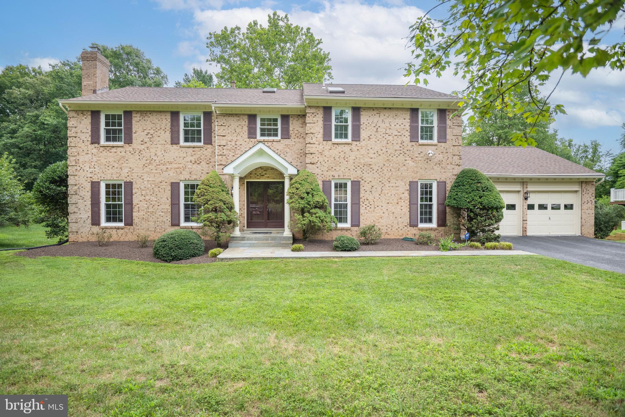 Located in the sought-after Lake Normandy Estates, this 4-bedroom, 3 full and 2 half bath brick colonial offers over 5200 square feet of gracious, updated living space. As one of the largest models in the subdivision, this home is both impressive and move-in-ready.
A double-door entry introduces this gorgeous residence, where a contemporary tiered chandelier warmly welcomes you. The main level features a spacious office, perfect for work-from-home days, a large living room, and an elegant dining room with a wall of new windows, beautiful crown moldings, and wainscoting. The formal living room boasts a wood-burning fireplace, while the dining room is illuminated by crystal chandeliers. The large family room features a wood-burning fireplace and skylights, with two doors opening to a new deck that overlooks a lush green backyard. The kitchen offers granite counters, an island, stainless steel appliances and a breakfast area with a picturesque window and side door to the deck. A mud/laundry room provides easy access to the oversized 2-car garage, which has newly painted floors.
Brand new windows enhance the main and lower levels, with upper-level windows replaced in October 2022. Gleaming refinished hardwood flooring is found on both the main and upper levels.
Upstairs, the light-filled primary bedroom suite is a fascinating oasis, comprising a bedroom, a sitting room, his and her walk-in closets, an en-suite bathroom with double vanity, a shower, and a skylight. Another separate room with a whirlpool tub offers a tranquil retreat. Three additional bedrooms, one of which is an en-suite, provide captivating haven for family and guests, along with a hall bath that features a separate vanity area and bathroom.
The lower level features a walkout door that leads to the patio, providing plenty of light in the basement. A huge recreation room with a wet bar, a powder room with space to convert into a full bath, and the potential for adding a fifth bedroom amplifies the home’s desirability. A large storage/workshop/utility room area completes this floor.
Perfectly situated, this home is just minutes from top-rated schools, shopping, restaurants, and houses of worship. Major transportation routes nearby ensure a convenient commute to Rockville, Bethesda, downtown Washington, and area airports. Embrace an easy and sophisticated lifestyle in this exceptional home. Come and see for yourself!
