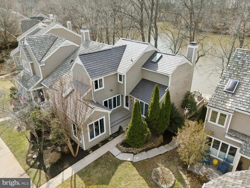 Experience lake side living at its finest in this exceptional WATERFRONT townhome located on the Island of Lake Montclair. This townhouse is a haven from the fast-paced life of Northern Virginia, offering views of the lake that can lower your blood pressure as you take a deep breath in this peaceful retreat. Enjoy private access to the water with your own dock, ideal for pontoon boating, stand-up paddle boarding, kayaking, or fishing on the 100+ acre stocked lake. This home features an inviting courtyard entry, leading into a beautifully designed interior with low maintenance LVP flooring throughout. 
The main level includes a bright and airy living room, surrounded by windows that frame the lake views, and anchored by a cozy woodburning fireplace. A sliding glass door opens to a deck that overlooks the water, making it the perfect spot to unwind or entertain. Above the fireplace, you will find a custom painting of the lake which conveys with the home. The painting has a jewel marking the property. The living room also features a wet bar, enhancing the space for entertainment. The main level office, which could easily be used as a fourth bedroom, offers practicality and flexibility. It has a sliding glass door with easy access to the deck, for those days when you just need a moment outside to take in the water views.  
The updated, eat-in kitchen boasts stainless steel appliances, quartz countertops, ample cabinet and counter space and a pantry. The skylight and floor to ceiling windows bring in lots of natural light, yet it still feels private. The dining room flows seamlessly between the living spaces and provides the perfect space for family meals or gatherings. 
The upper level offers two bedrooms, each with its own private bathroom. Start your mornings bird watching and finish each day with views of the sunset from the large picture window in the primary bedroom. The primary suite also offers vaulted ceilings, a walk-in closet, skylights, and a newly renovated primary bath with a stand-alone soaking tub.
The lower level includes a spacious family room with a stone gas fireplace, a large wet bar with storage, and a beverage fridge and wine cooler, creating a perfect space for entertaining. A third bedroom on this level makes a lovely retreat for guests, offering privacy and easy access to the outdoors through the sliding glass doors to the lower deck.  Additionally, the lower level includes a laundry room with Samsung large capacity washer and dryer (2022), a 14.8 cubic foot freezer (2022) and extra storage space, ensuring everything has a place in this well-appointed home.
This home is ideally located just 40 minutes from the Pentagon and the DC line, with easy access to nearby commuter lots, bus stops, and I-95. The Montclair community has a variety of amenities, including basketball courts, tennis courts, baseball fields, and a dog park. Enjoy the three beaches Montclair has to offer, boating on the 108-acre Lake Montclair, fishing, and exploring the many playgrounds, including Kids Dominion.  Families will appreciate the award-winning schools in the area. The neighborhood features a library, variety of restaurants, and a grocery store, providing convenience for daily needs and activities. This home offers a great combination of location and community amenities.

All major systems have been updated. HVAC 2024, Water Heater 2024, Roof with Enviro-shakes 2024 (33k+)