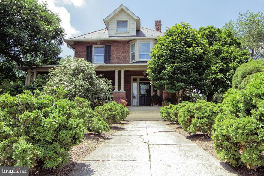 Stately brick home with 10' ceilings, huge windows, wide trim and original millwork, wraparound porch, large corner lot, meticulously landscaped with specimen trees.