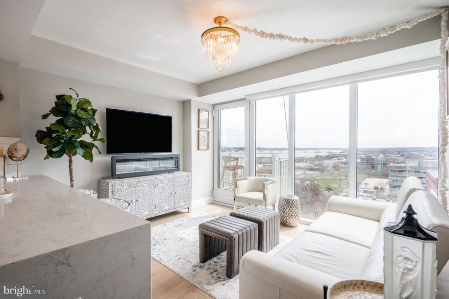 Seldom available one bedroom, plus den with river views. Wait until you see the view through floor to ceiling windows! Property comes with a 9'.6" x 9'6" x 8' Storage room (#10) with light and a parking space directly in front of the storage unit. The ultimate in Old Town condo living. This LEED certified concierge level building with incredible amenities including a sky lounge, state of the art fitness center with a Barre studio, rooftop terrace with fire pits is the perfect no maintenance, top caliber living experience. With direct access to the Mount Vernon Trail and Montgomery Park with tennis courts, playground and weekly Farmer's Market, as well as the Montgomery Park dog park and a dog wash located in the building garage, it is not only the ideal place for an active lifestyle for all ages but for your furry family members as well. Walking in the door, the river views are striking! With an incredible gourmet kitchen complete with waterfall quartz counters, custom cabinets and tile backsplash, cook with a view. Open dining and living spaces with high ceilings and pristine hardwoods including a private balcony. The primary bedroom has ample walk-in closet space with a spa like primary bath complete with quartz vanity and oversized custom tile shower. A den with sliding barn door is the perfect flexible space - home office, guest room, home yoga studio - so many options to make this condo your own. Tons of eclectic shops, acclaimed restaurants, parks and services just outside your door including a Metro station within walking distance. National airport a simple Uber ride away for busy travelers! Welcome home!