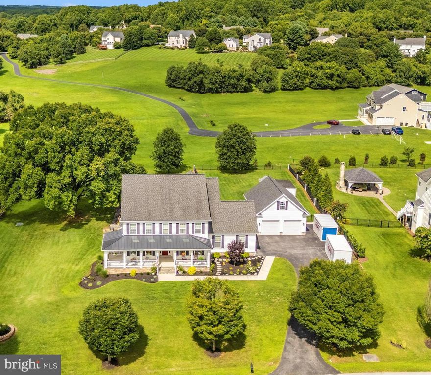 This stunning custom-built home offers a serene retreat on over an acre of beautifully landscaped land. The property features more than 6000 square feet of living space to include an In-law suite on the main level, with separate entrance, private laundry, and private deck. Perfect
for multi-generational living or accommodating guests. The spacious well equipped kitchen and open floorplan are an entertainer’s dream, with integrated speakers throughout the home andoutside, providing the perfect ambiance for any occasion. Step outside onto the sprawling deck
to enjoy the extensive hardscaping, partially fenced yard, and breathtaking views of the surrounding countryside. The private porch off the primary bedroom is a tranquil spot to start or end your day. You will be treated to the calming sounds of morning nature, and striking evening
sunsets from either spot. The heated, oversized garage offers a convenient storage loft, an EV hook up, plenty of space for parking and room for a workshop. The home is also equipped with a buried, owned, 1000 gallon propane tank and whole home generator. Tucked away in a quiet
neighborhood, with the school bus stop at the bottom of the hill, this home is the perfect blend of privacy and convenience. While you’ll enjoy the peace and tranquility of its secluded setting, you're still just minutes away from all the amenities that Maple Lawn has to offer. Baltimore,
Annapolis, Washington DC, Rockville, Alexandria, and Frederick are all within an hours drive. Whether it’s shopping, dining, or community activities, everything you need is within easy reach, allowing you to enjoy the best of both worlds—serene living with the benefits of a well-connected location.